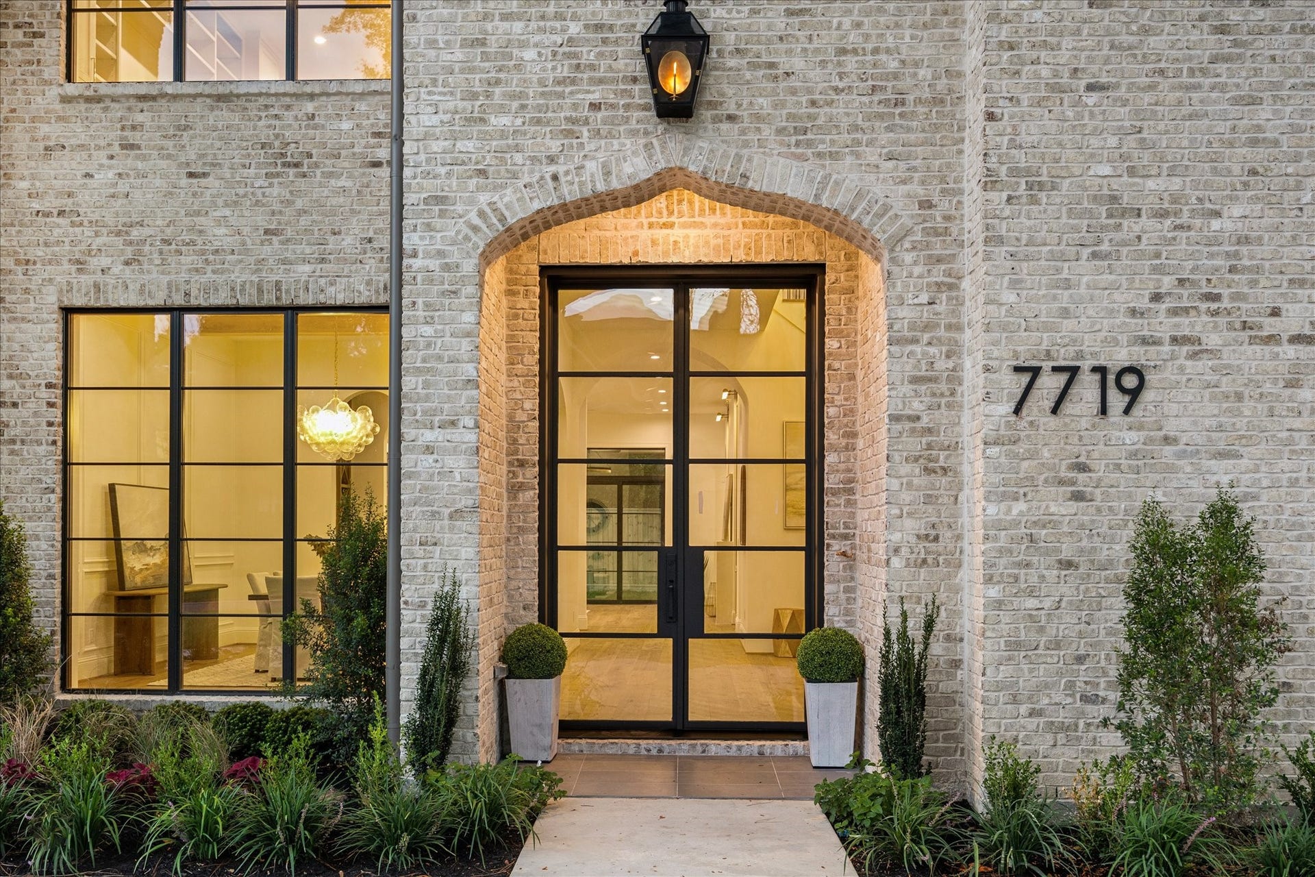 7719 Bryonwood Drive, Houston, TX 77055 Black-framed glass double doors offer a first look into the light-filled interior.