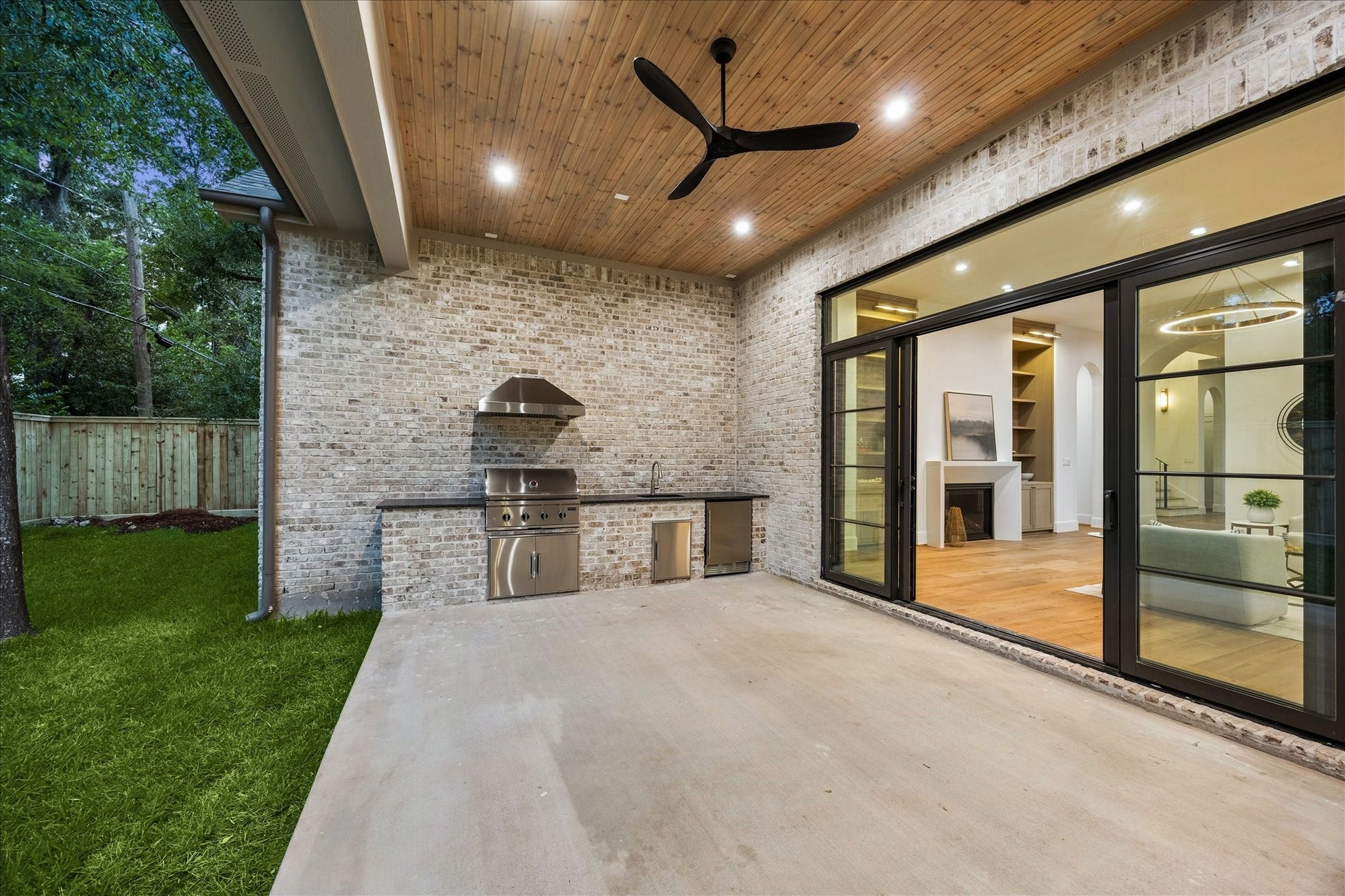 7719 Bryonwood Drive, Houston, TX 77055 The covered patio has a full outdoor kitchen beneath a tongue-and-groove wood ceiling.
