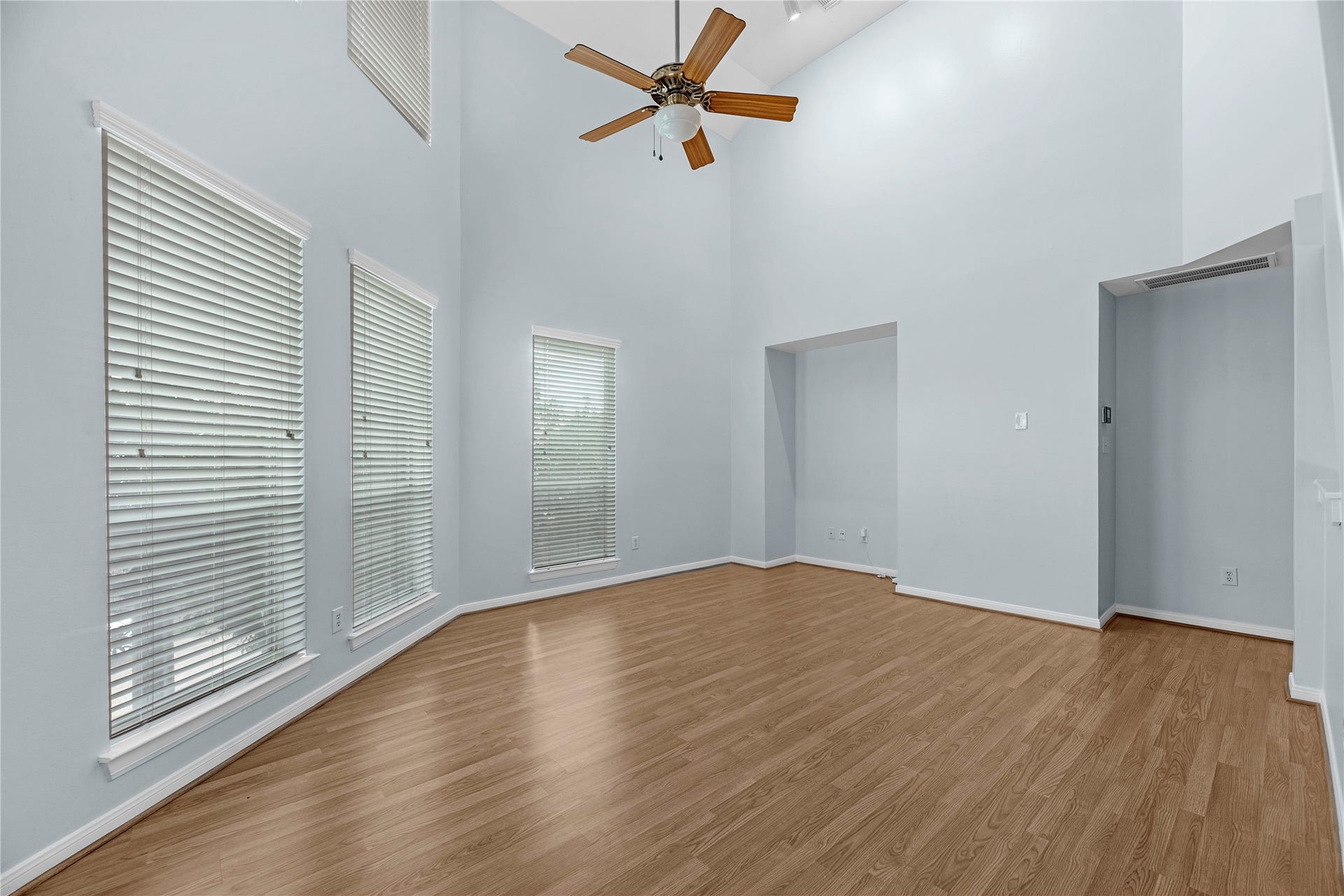 1712 Bevis Street, Houston, TX 77008 Natural light fills the living area through large windows with plantation shutters, while high ceilings, updated flooring, and a ceiling fan create a bright and comfortable gathering space.