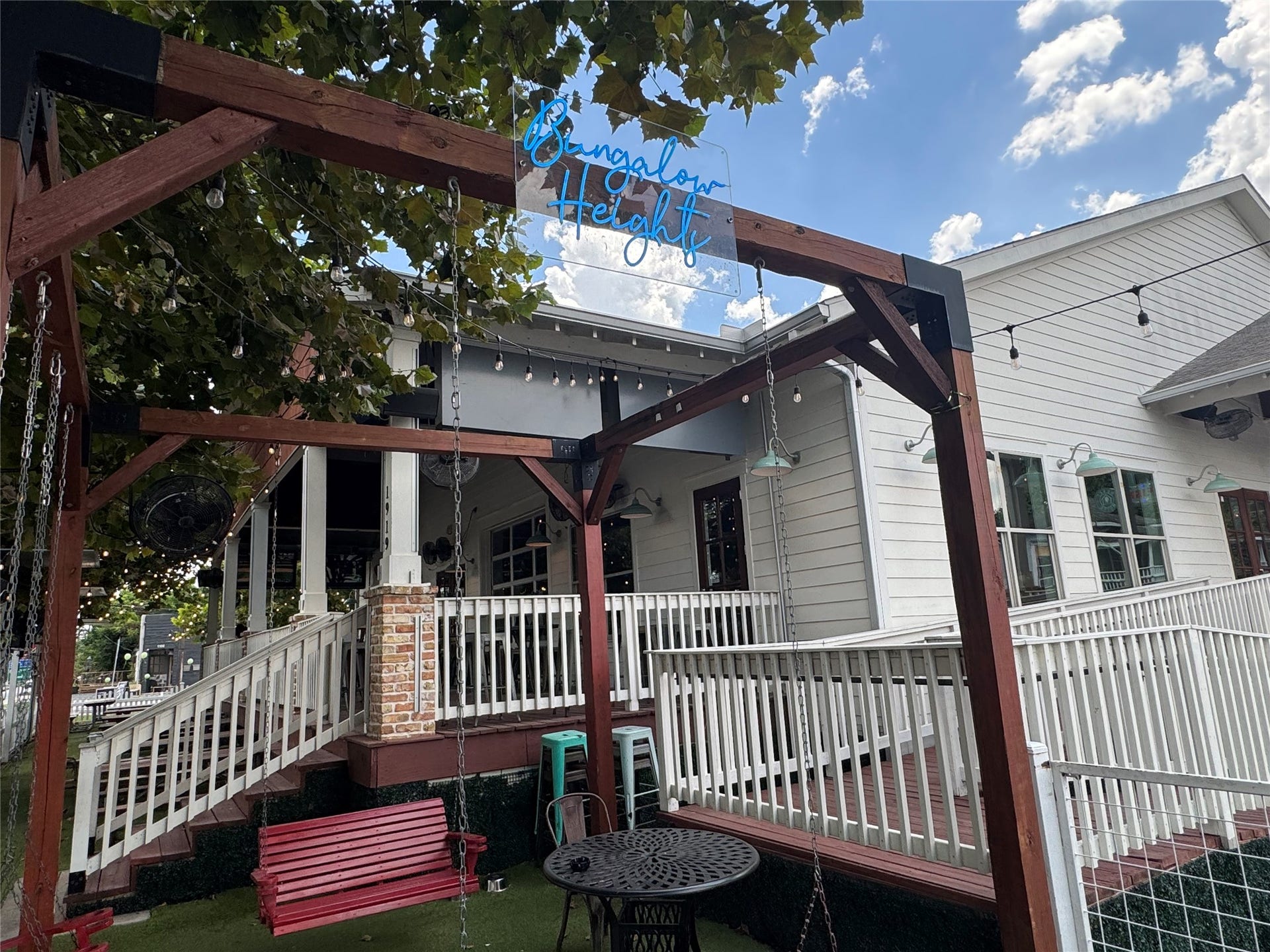 1712 Bevis Street, Houston, TX 77008 Bungalow Heights features a spacious outdoor seating area with swings and a relaxed atmosphere, providing another nearby spot to gather with friends and enjoy the neighborhood.