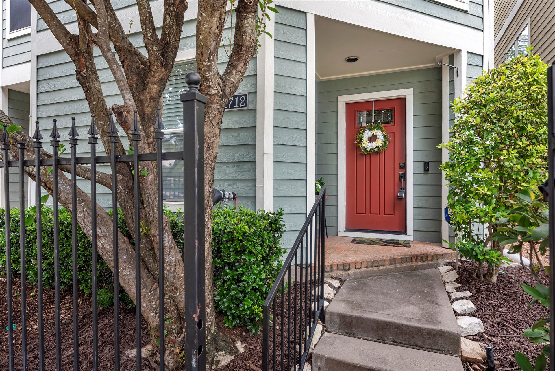 1712 Bevis Street, Houston, TX 77008 The inviting front entry features brick pavers and fresh plants recently added by the seller for the new owners to enjoy. The seafoam green exterior and covered entry create a welcoming approach to the home, while ongoing front landscaping is included through the HOA for added convenience.