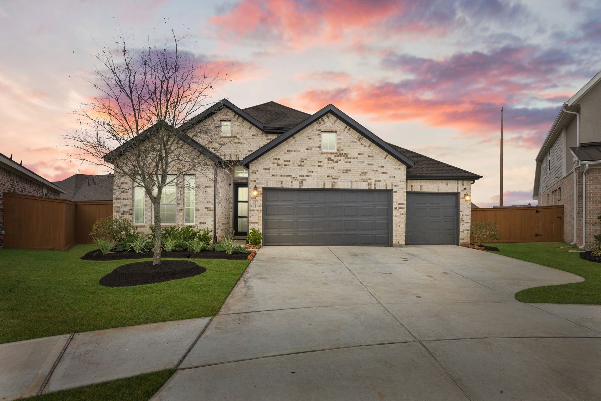 Striking brick elevation with clean rooflines and a three-car garage creates strong curb appeal, beautifully set within this growing Katy 77493 community.