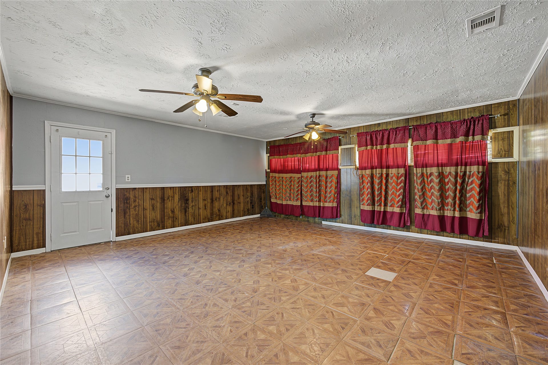 7510 Baneway Drive, Houston, TX 77072 Spacious living and entertaining area featuring a mix of rich wood paneling and fresh interior paint.