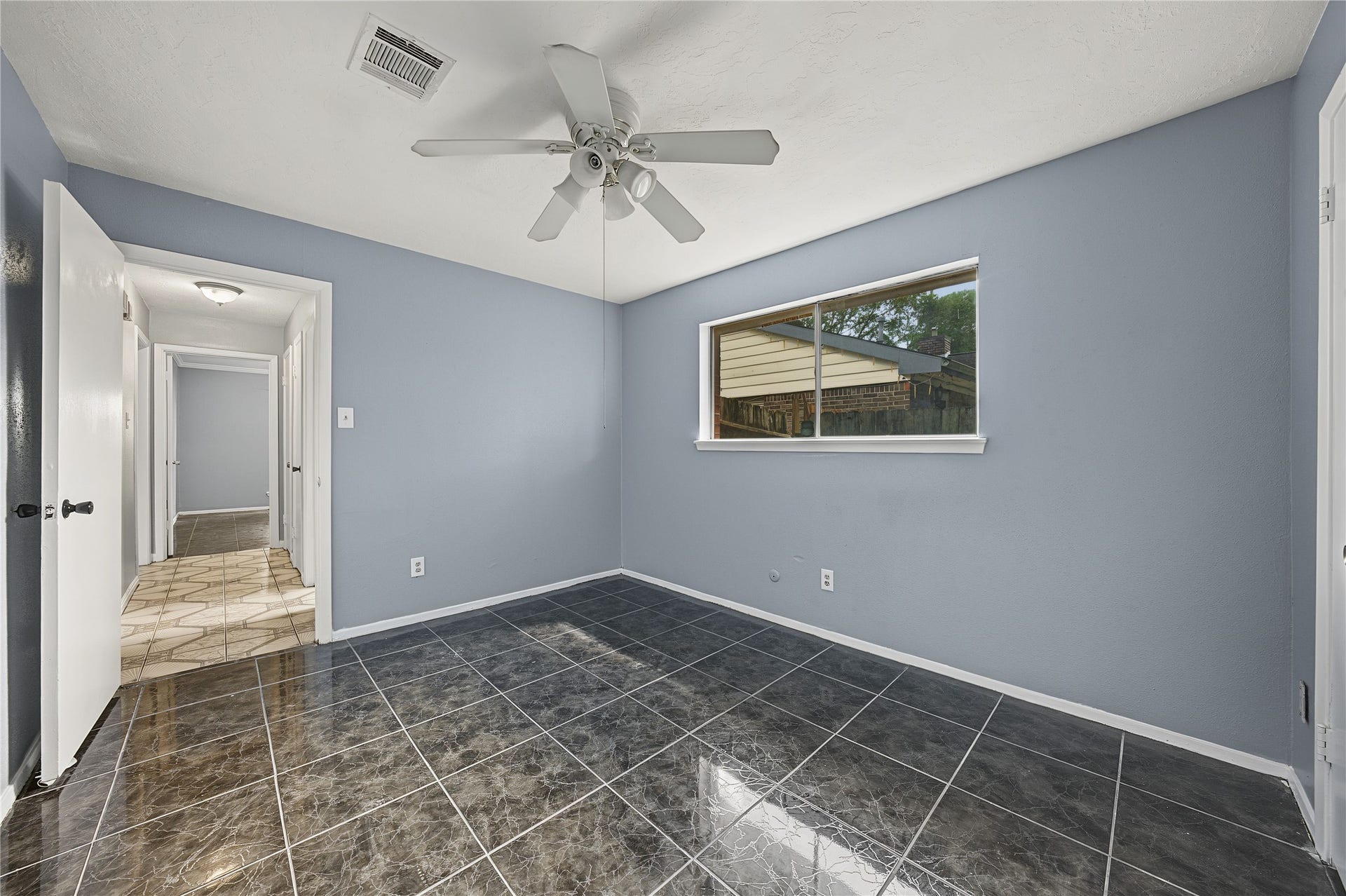 7510 Baneway Drive, Houston, TX 77072 Secondary bedroom featuring fresh interior paint and tile flooring.
