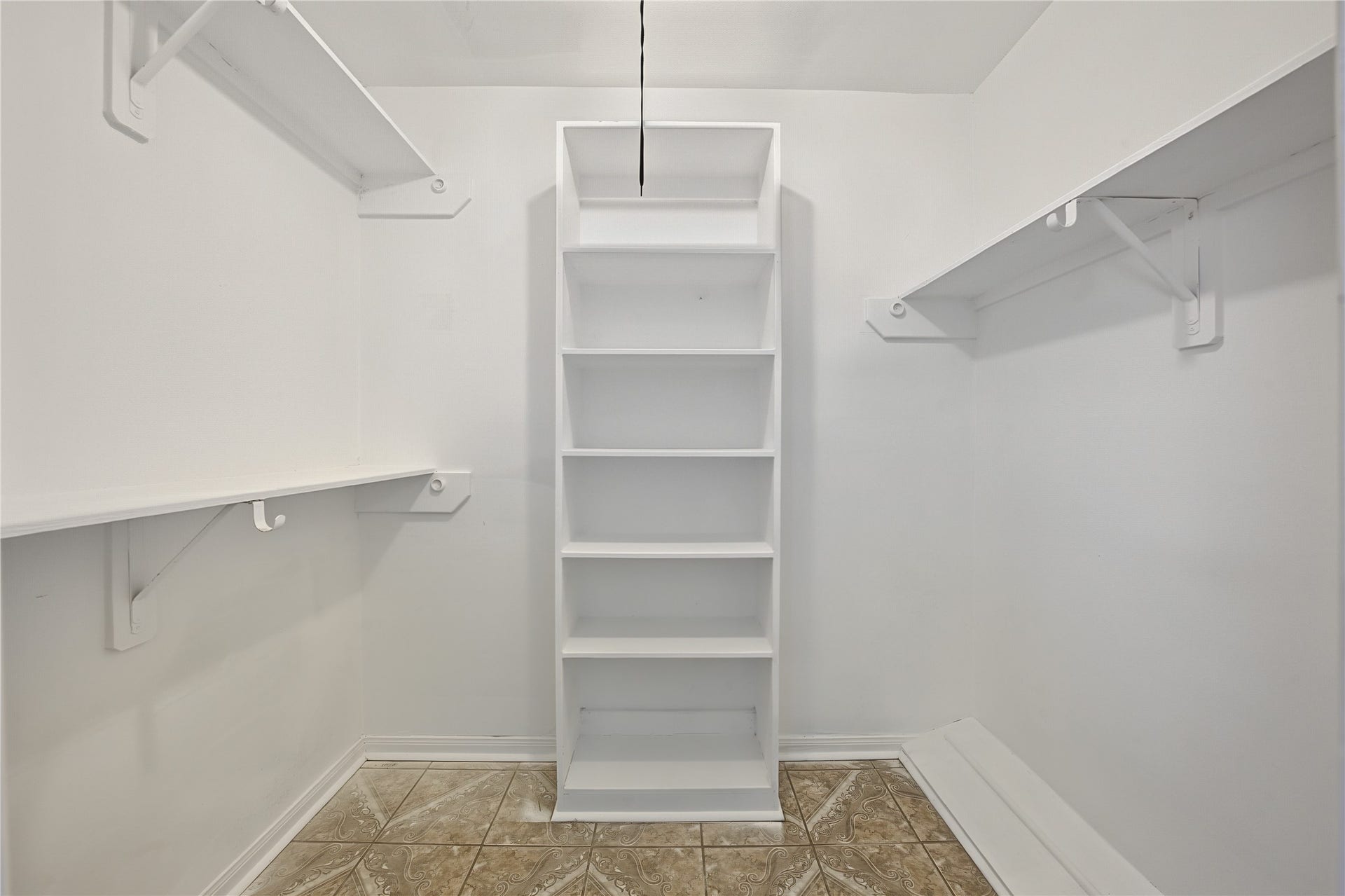 7510 Baneway Drive, Houston, TX 77072 Spacious primary walk-in closet featuring custom built-in shelving and fresh interior paint.