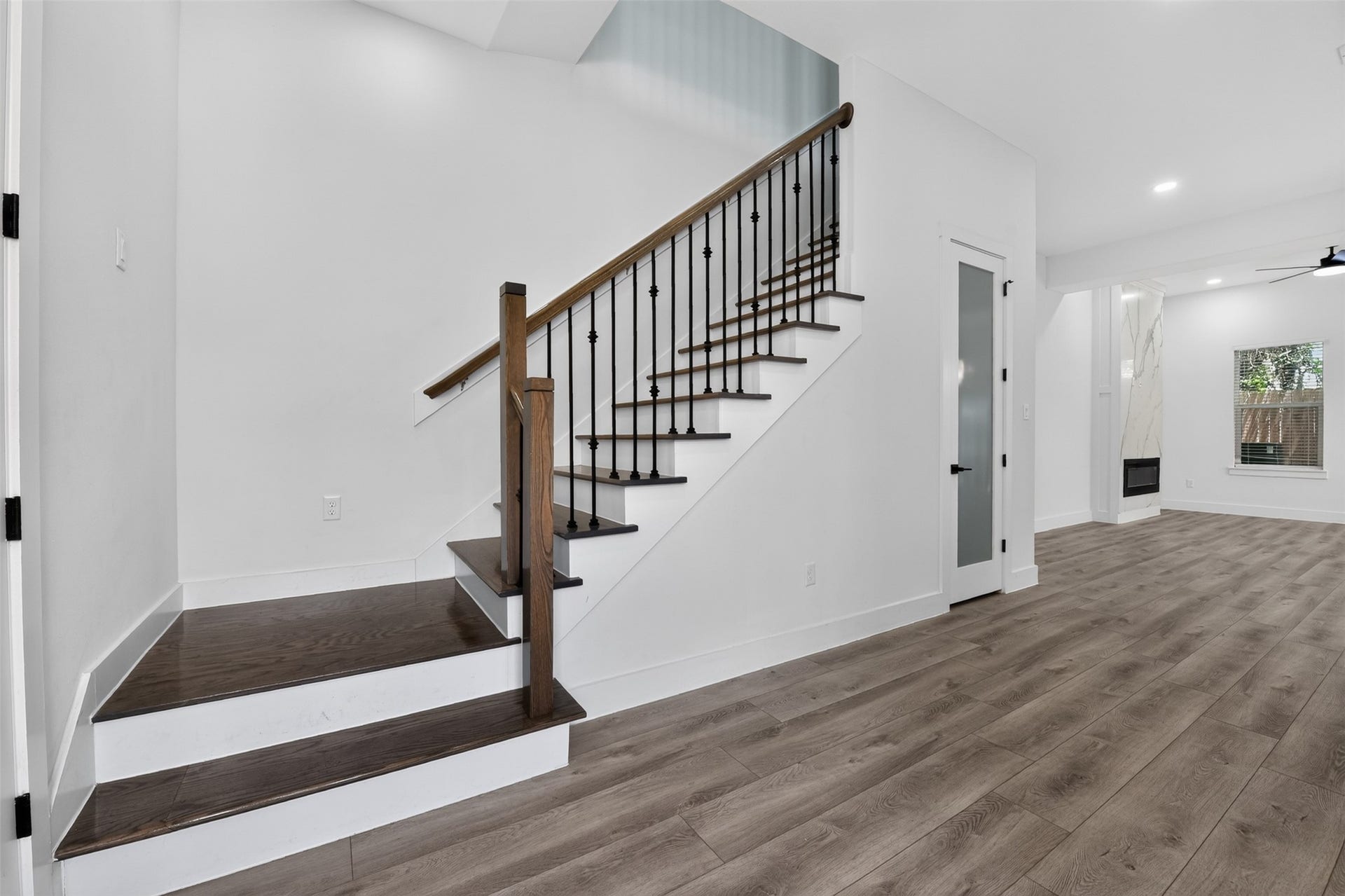 2911 Wichita Street, Houston, TX 77004 The expansive staircase serves as a graceful connection between floors, leading from the main living areas to a thoughtfully designed second level featuring private bedrooms and a flexible living space.