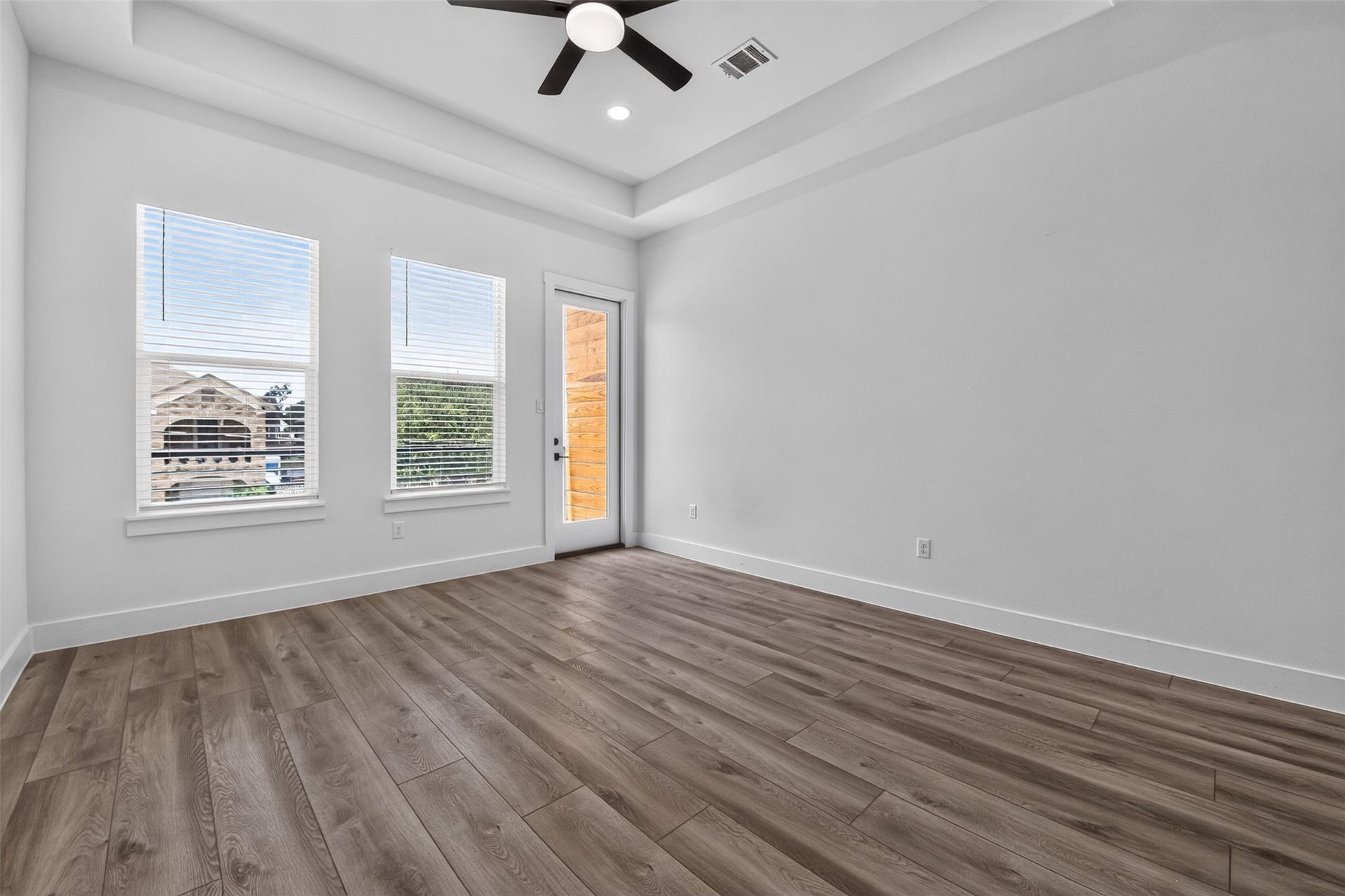 2911 Wichita Street, Houston, TX 77004 A closer look at the elegant primary bedroom, where comfort meets sophistication with the private balcony offering a peaceful outdoor escape.