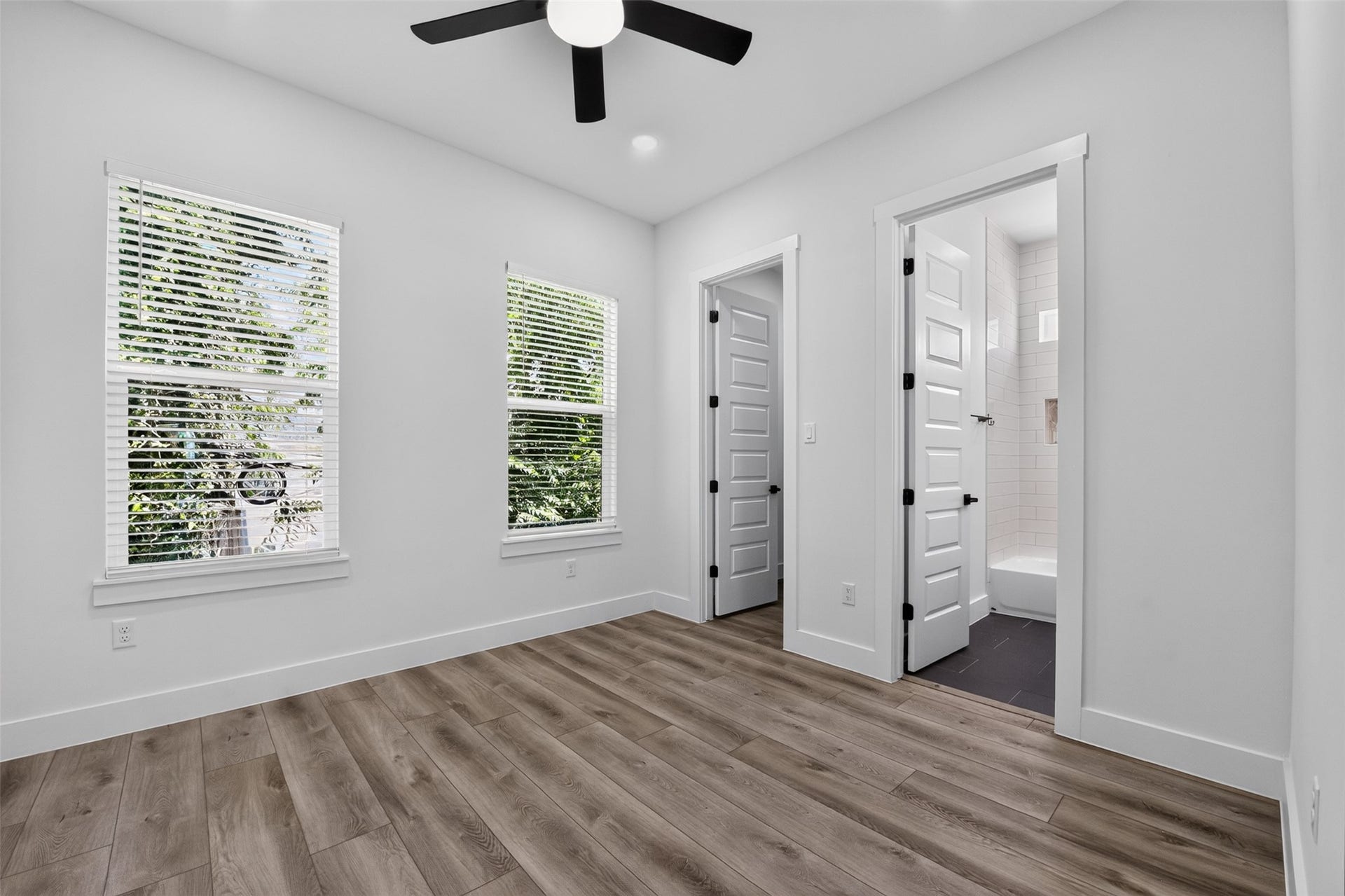 2911 Wichita Street, Houston, TX 77004 A serene secondary bedroom suite positioned above the living area, offering a peaceful retreat with views overlooking the private backyard.