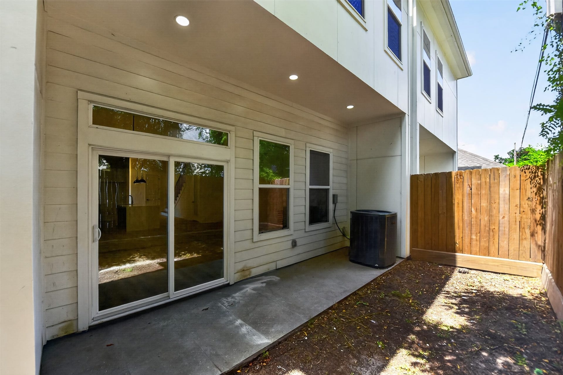 2911 Wichita Street, Houston, TX 77004 Seamless indoor-outdoor living awaits with direct access from the living room to a covered backyard retreat framed by a tall privacy fence.