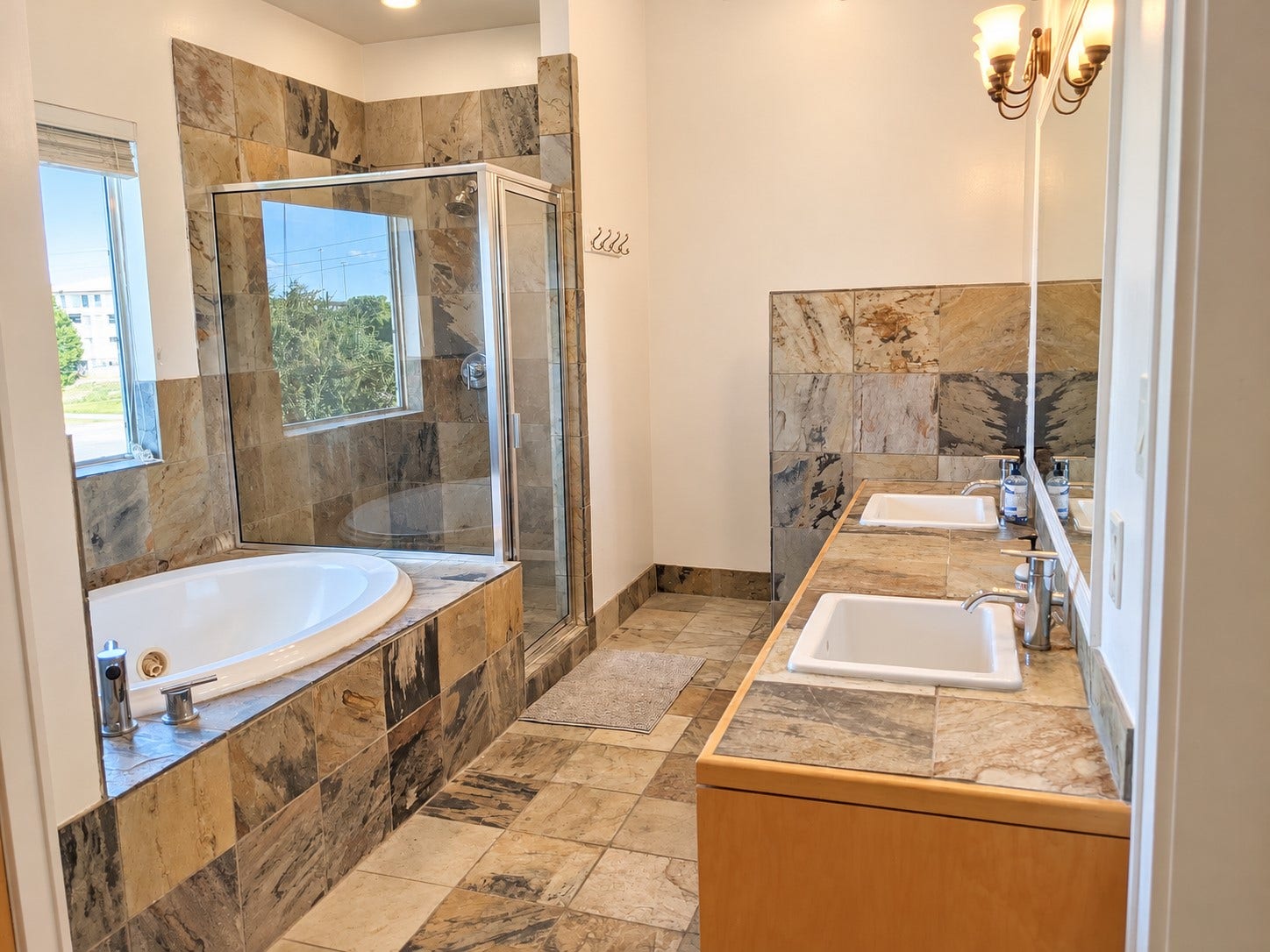 Comfortable primary retreat featuring a soaking tub and detached shower.