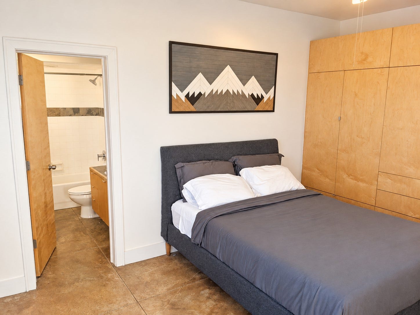 Furnished downstairs bedroom offering a comfortable, private space for guests or roommates.