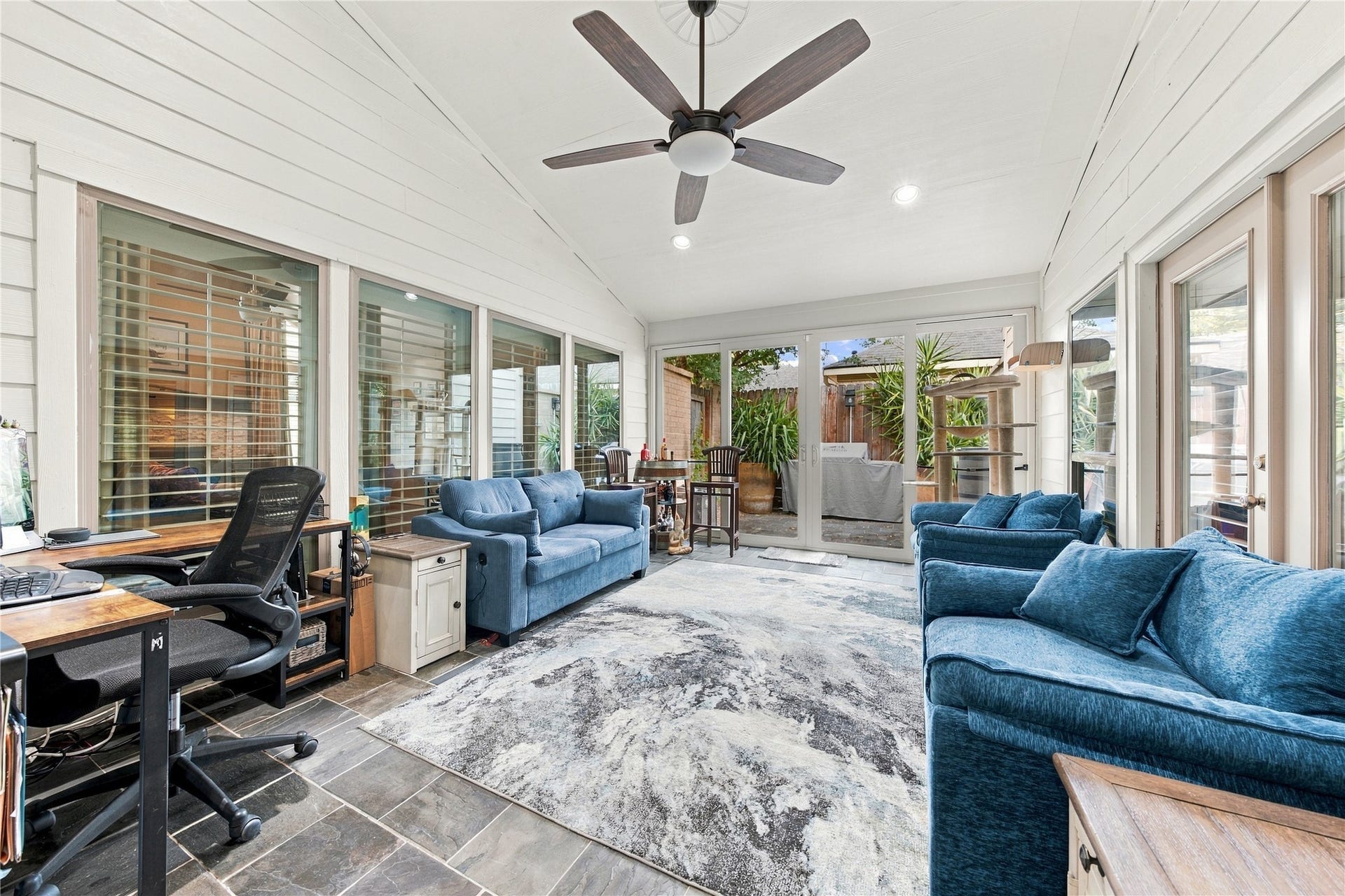 3211 Chris Drive, Houston, TX 77063 The sunroom is a true standout! A vaulted white-planked ceiling, slate tile floors & a wall of sliding glass open straight to the patio, while shuttered windows & French doors connect it to the rest of the home.