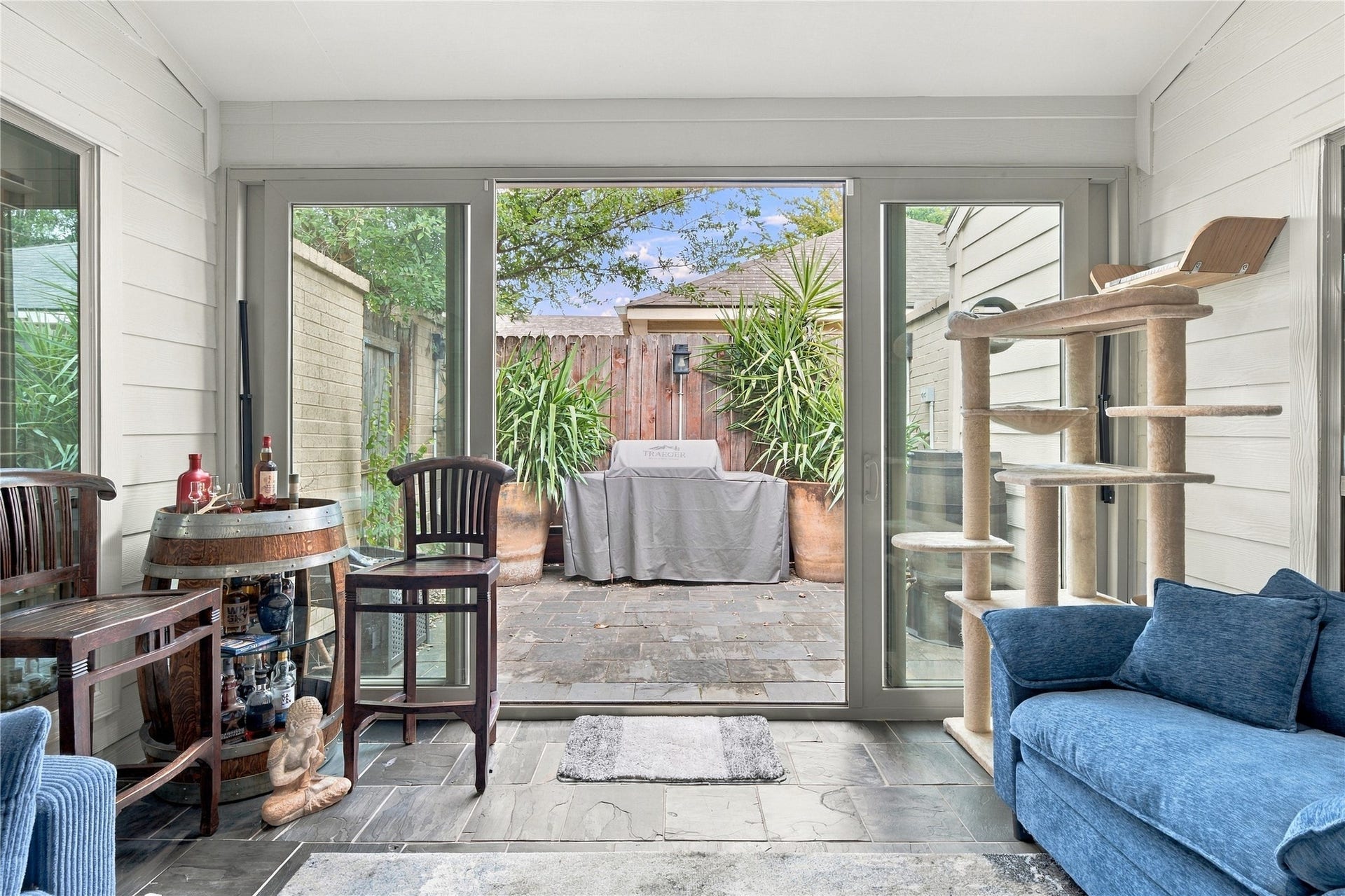 3211 Chris Drive, Houston, TX 77063 Wide sliding glass doors open the sunroom directly to one of the home's patios, letting the indoor & outdoor spaces work as one.