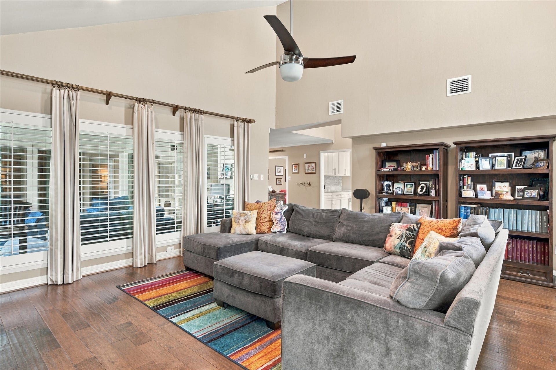 3211 Chris Drive, Houston, TX 77063 A full wall of shuttered windows looks directly into the sunroom, borrowing its light & adding depth to the living room.