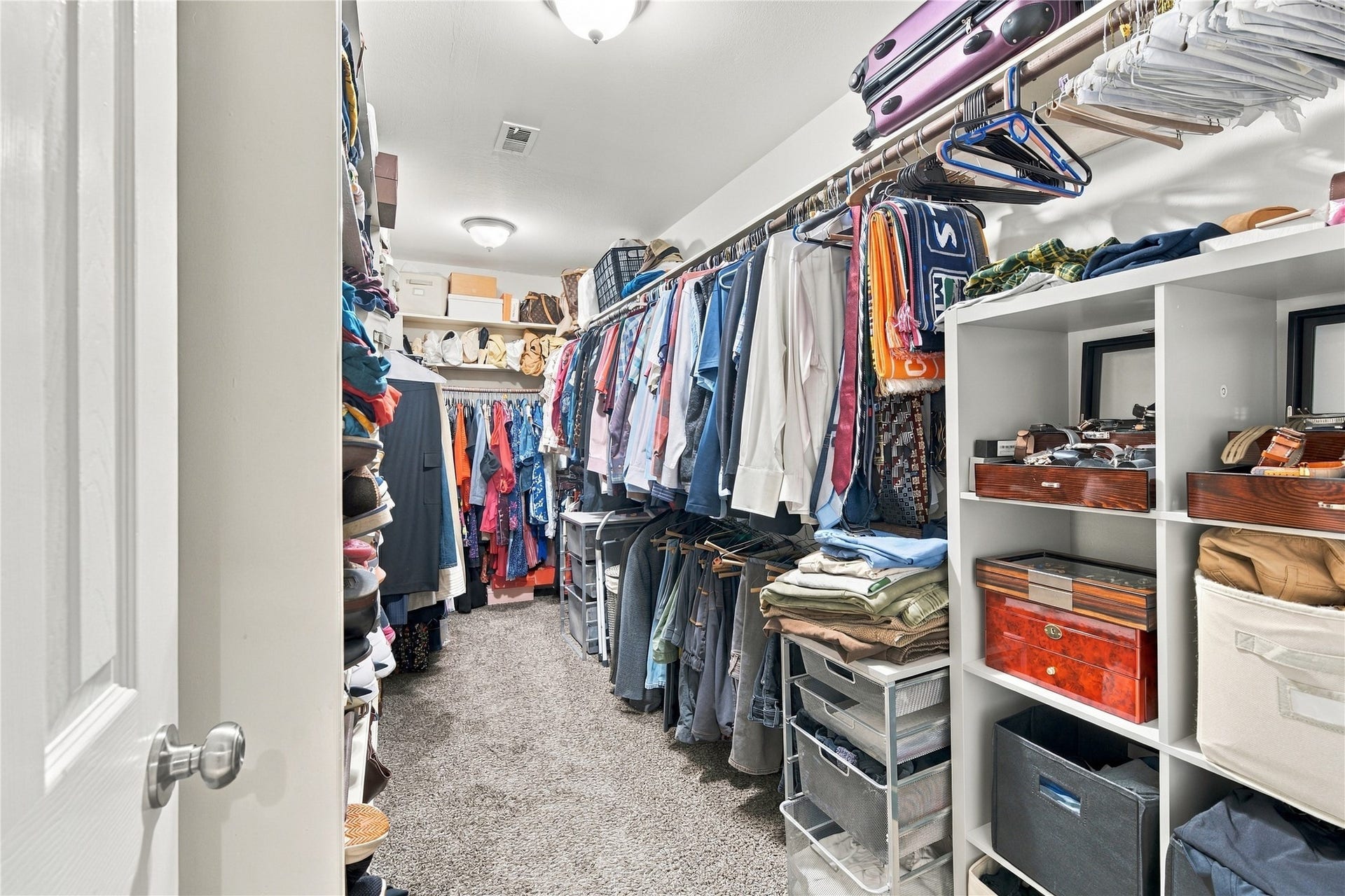 3211 Chris Drive, Houston, TX 77063 Spacious primary walk-in closet w/ long hanging rods & full-length shelving along the side wall, plus a second rod & shelf across the back. Plenty of room for a full wardrobe, shoes & seasonal storage.