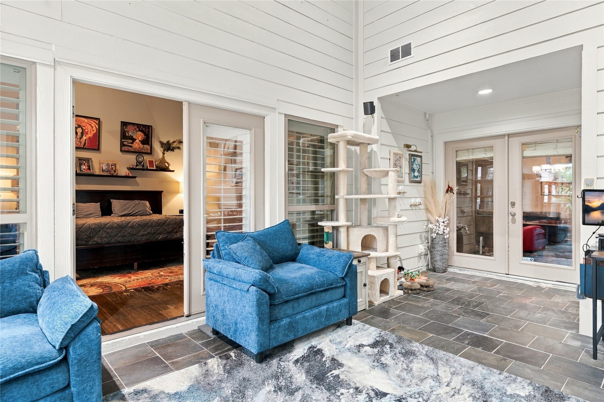 3211 Chris Drive, Houston, TX 77063 French doors open from the sunroom into the primary suite, placing the sunroom at the center of the home between the living spaces & the private wing.