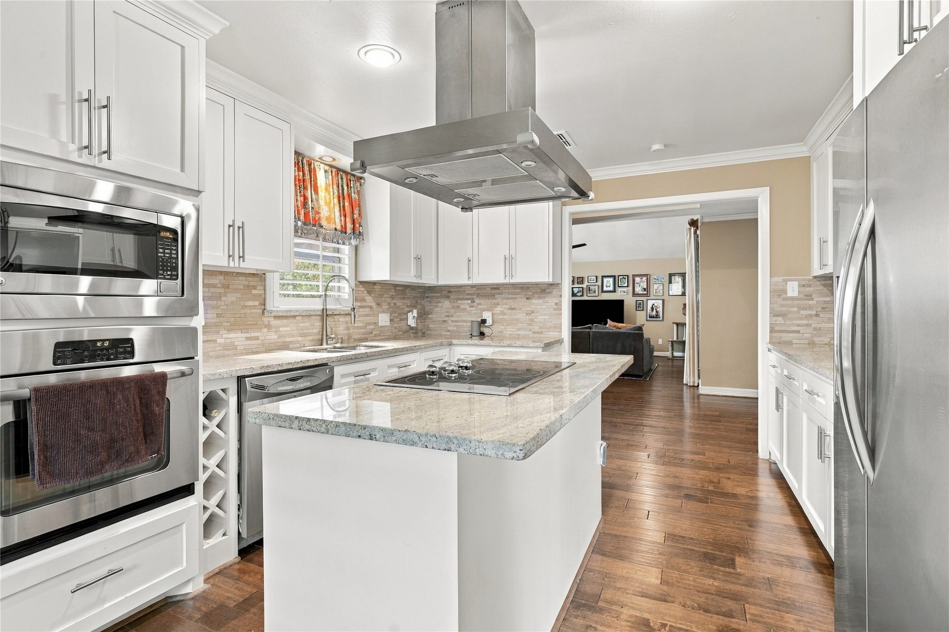 3211 Chris Drive, Houston, TX 77063 A built-in wall oven & microwave sit at the end of the cabinet run, a built-in wine rack beside the dishwasher and the granite island offering generous prep space round out this stunning kitchen.