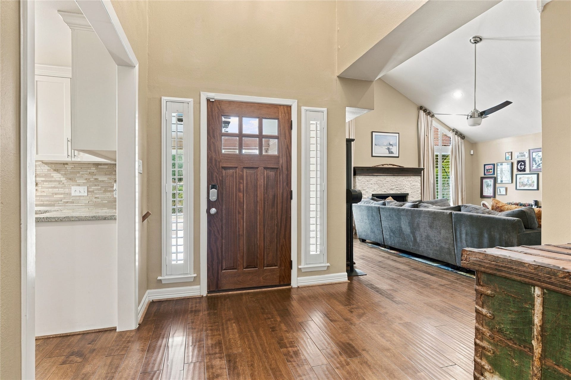 3211 Chris Drive, Houston, TX 77063 This welcoming foyer is draped in natural light through the plantation windows beside the wood door.