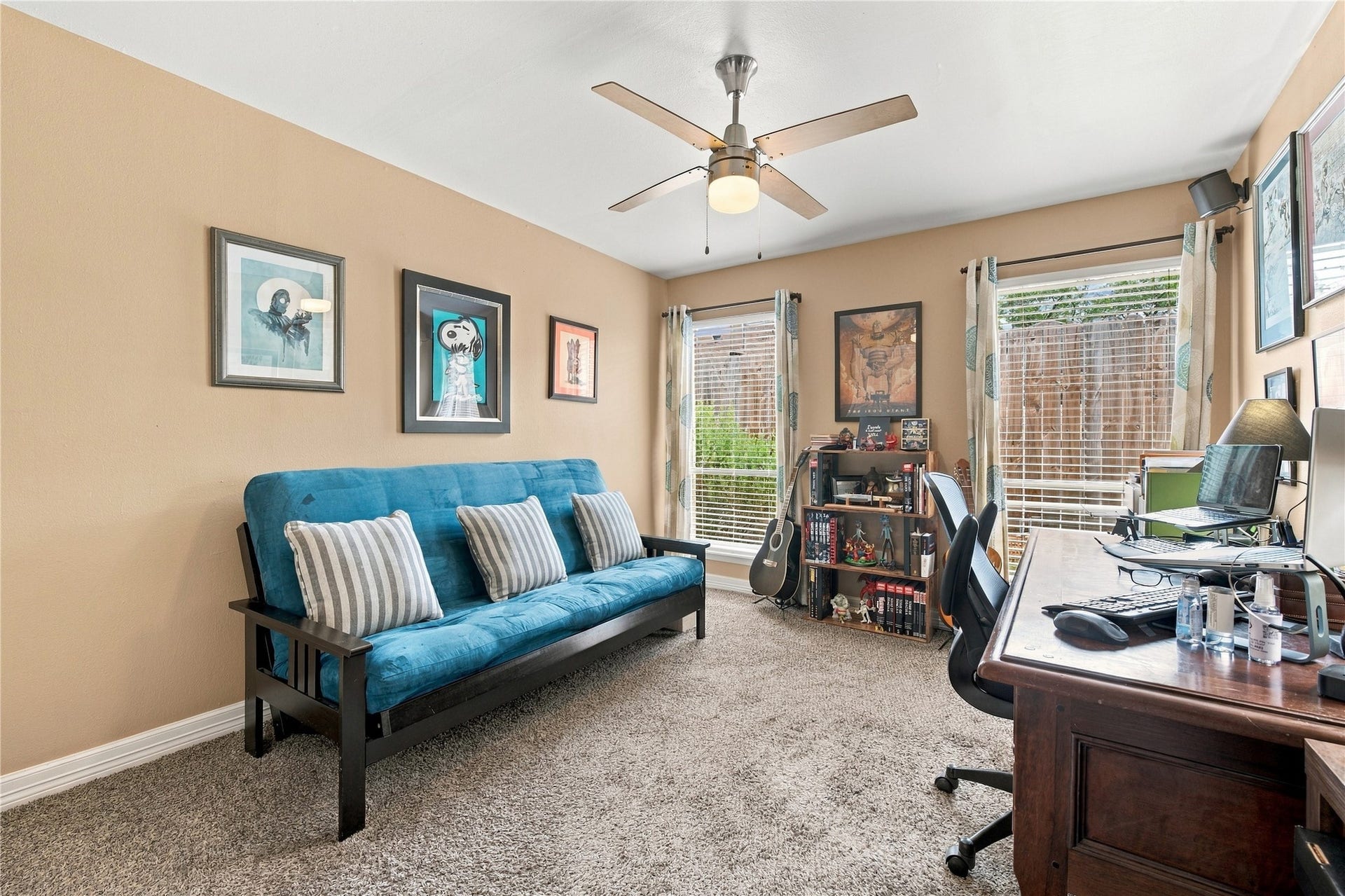 3211 Chris Drive, Houston, TX 77063 Secondary bedroom features plush carpet, a ceiling fan & two windows that bring in plenty of natural light. Currently set up as an office, it works equally well as a bedroom or guest room.