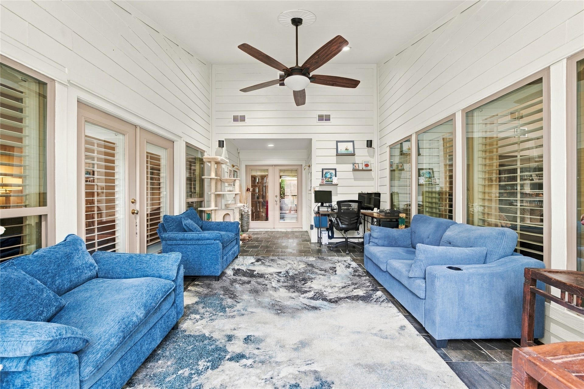 3211 Chris Drive, Houston, TX 77063 Relaxed, porch-like sunroom w/ ceiling fan & recessed lighting for year-round comfort, ideal for morning coffee, a reading nook, or a home office. French doors at the far end carry the flow into the rest of the home.
