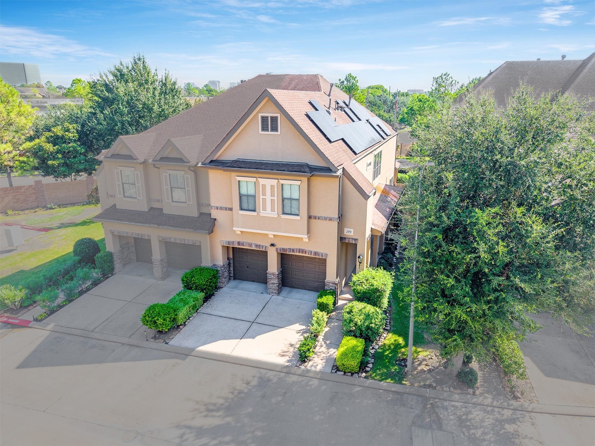 2919 Royal Oaks Crest, Houston, TX 77082 Elegant two-story home with a charming faade, featuring solar panels and a neatly landscaped front yard, nestled in a serene neighborhood.