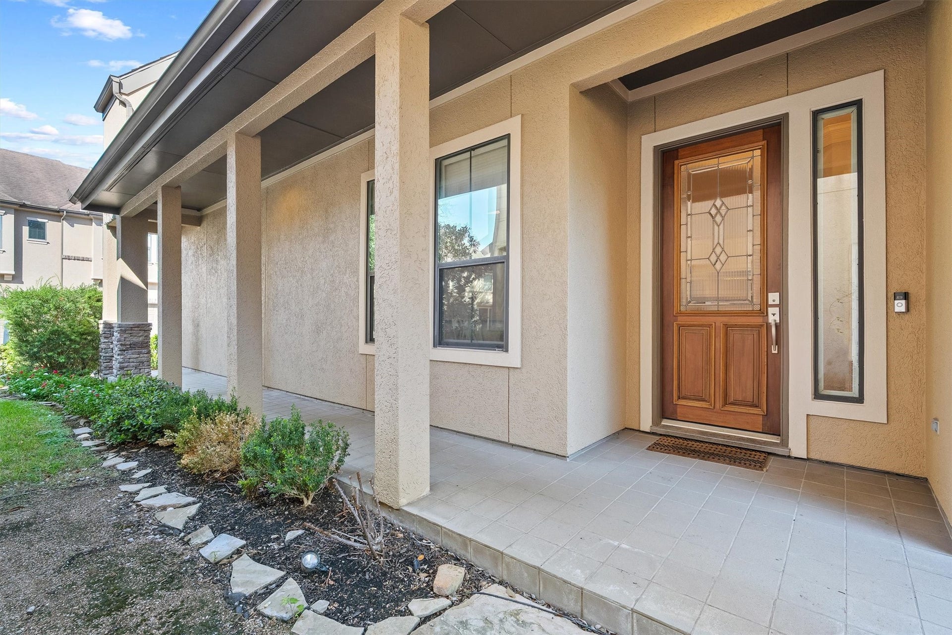 2919 Royal Oaks Crest, Houston, TX 77082 Front porch with elegant columns and a beautifully detailed wooden door, offering a warm and inviting entrance.