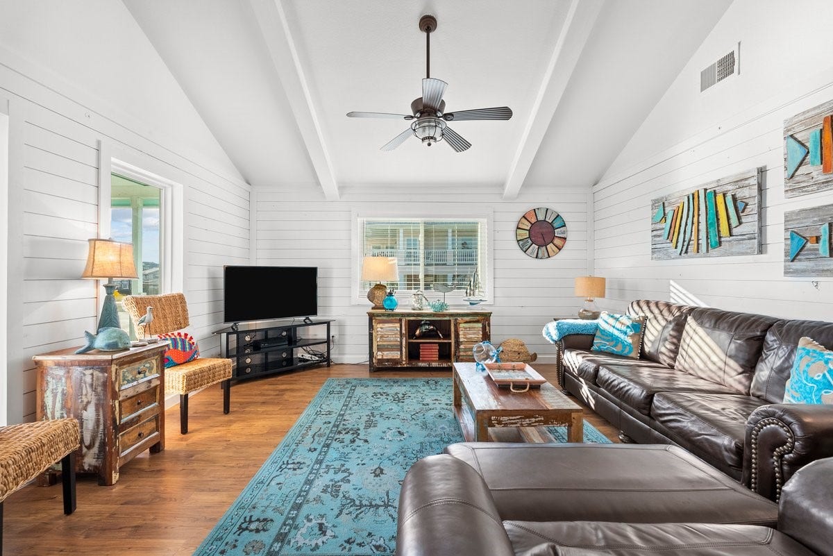 2406 Avenue P, San Leon, TX 77539 This inviting living room creates a warm and stylish atmosphere perfect for relaxation or entertaining.