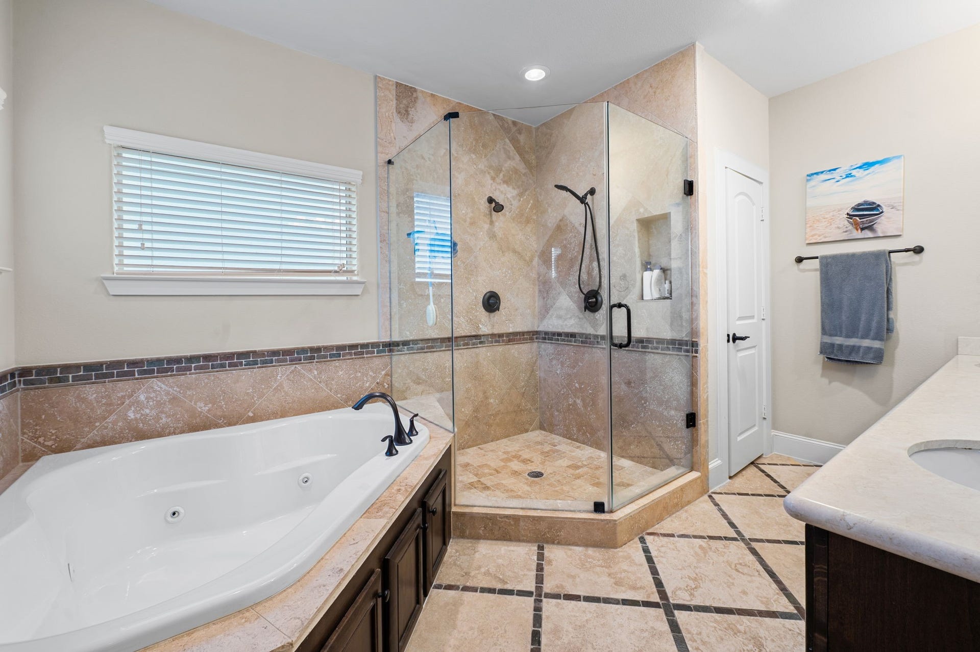The primary bath is a retreat in its own, and is equipped with a jetted tub, a walk in shower with frameless glass, double shower heads and a double sink.  A perfect way for a couple to save time ;)