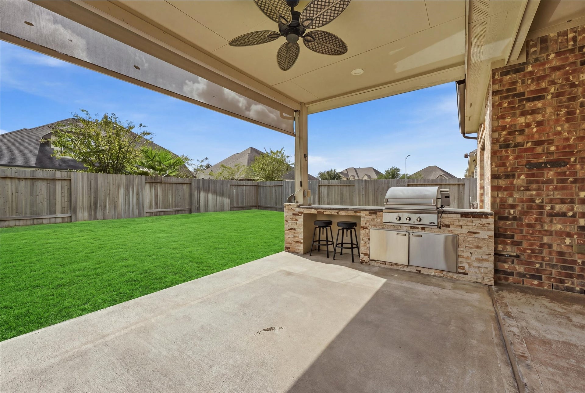 Fire up the built-in gas grill and enjoy dinner outside, with covered seating space and an open view of the backyard.