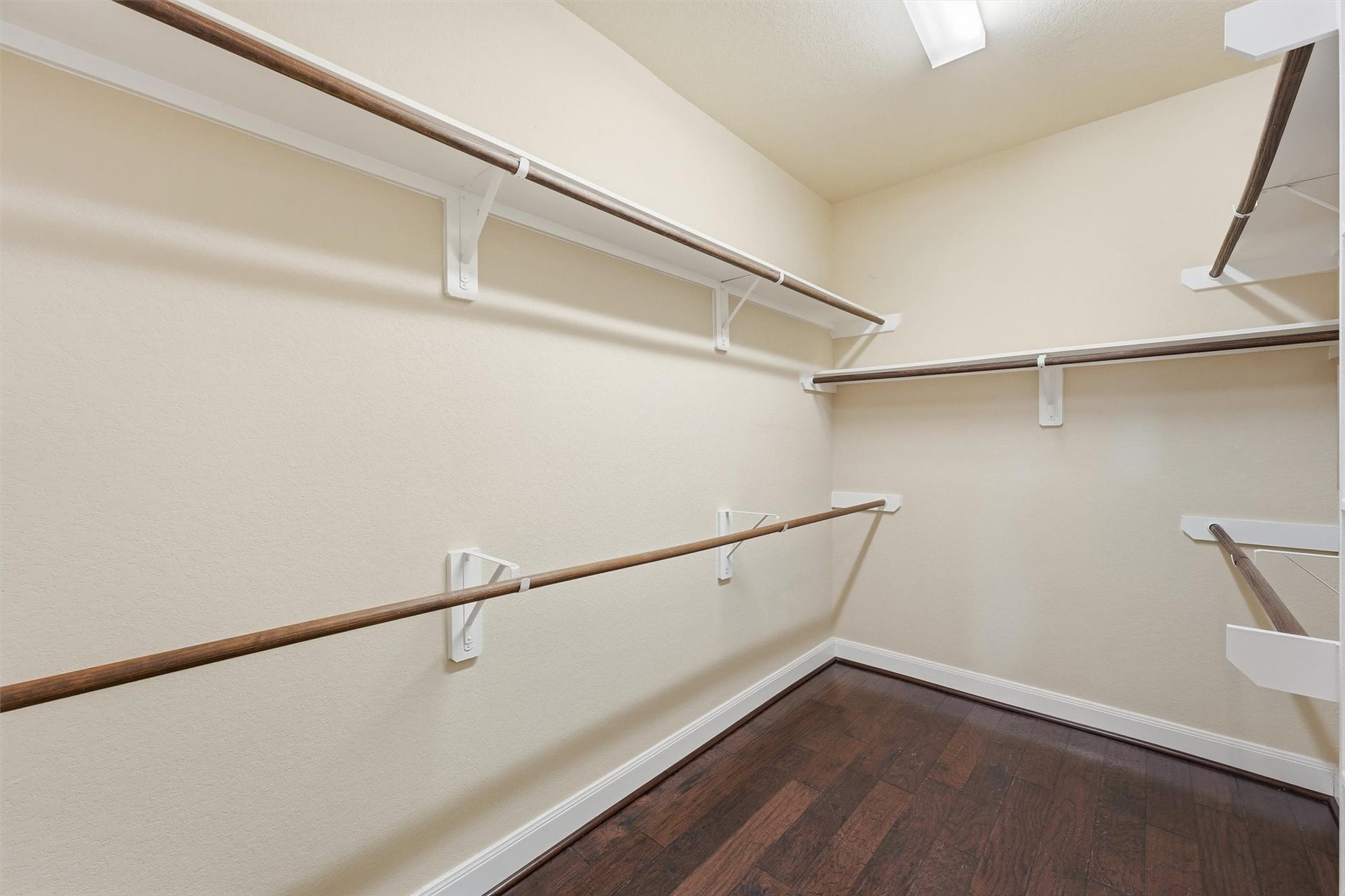 Primary bathroom with double sinks, jetted tub, separate shower, and large walk-in closet.
