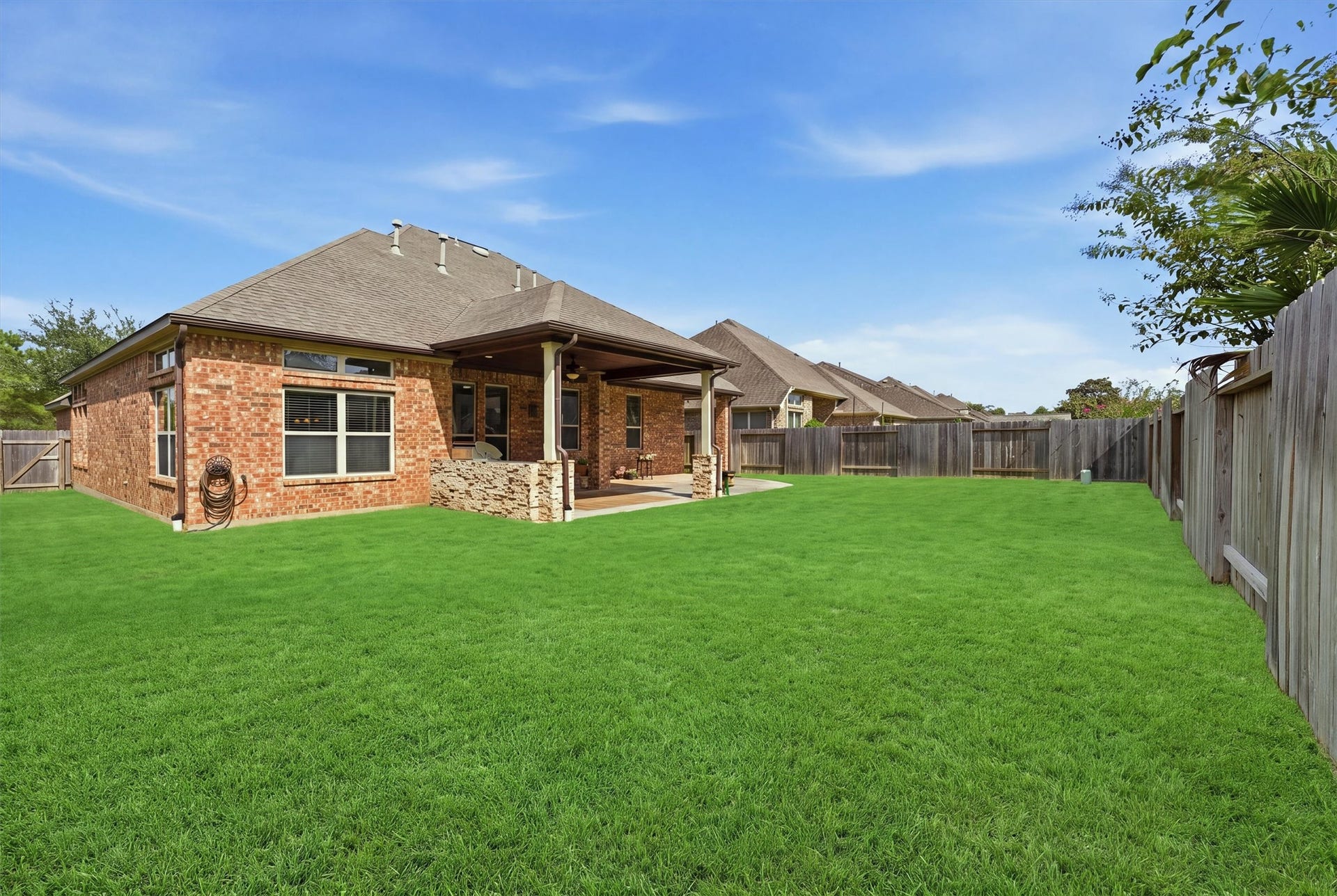 A generous lawn offers room to play, garden or imagine your next backyard project, with front and back sprinklers for easy watering.