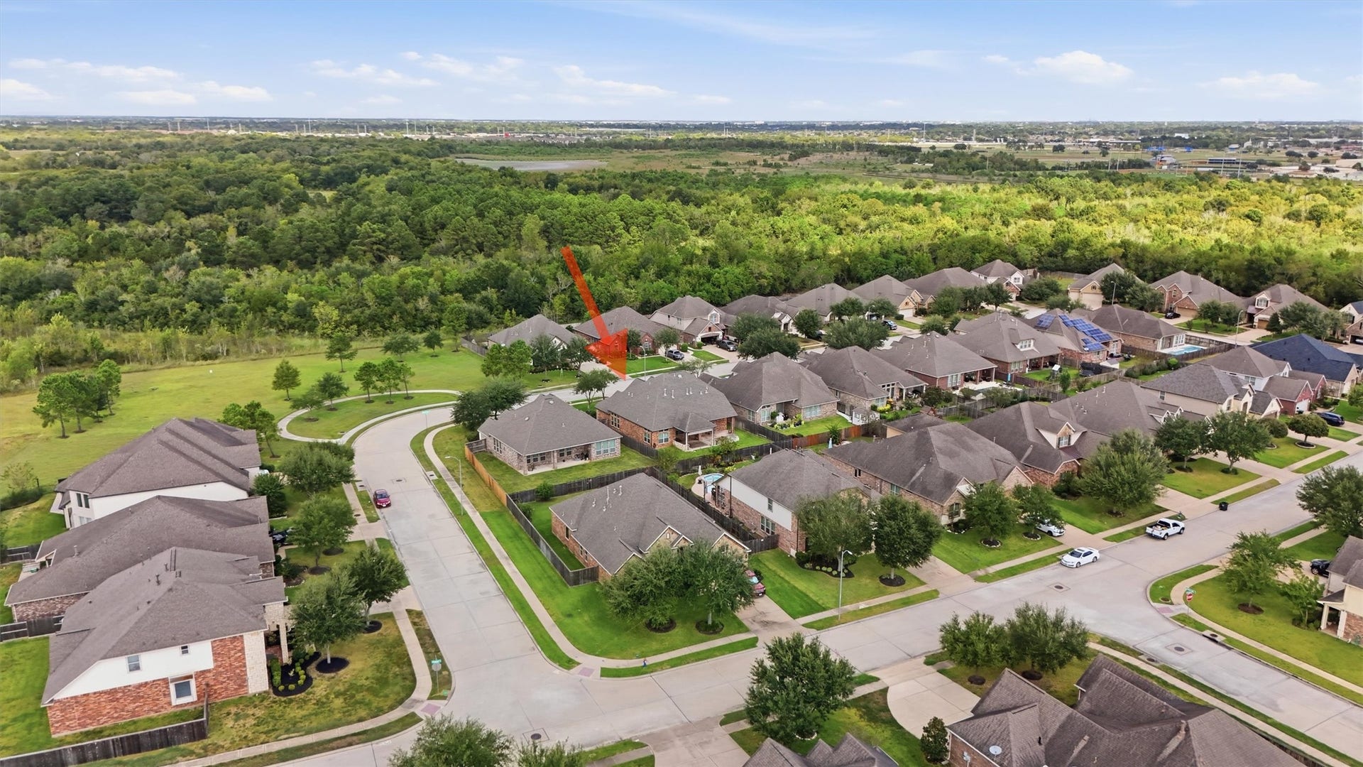 A wider look at the neighborhood, with green space and walking trails directly across from the home.