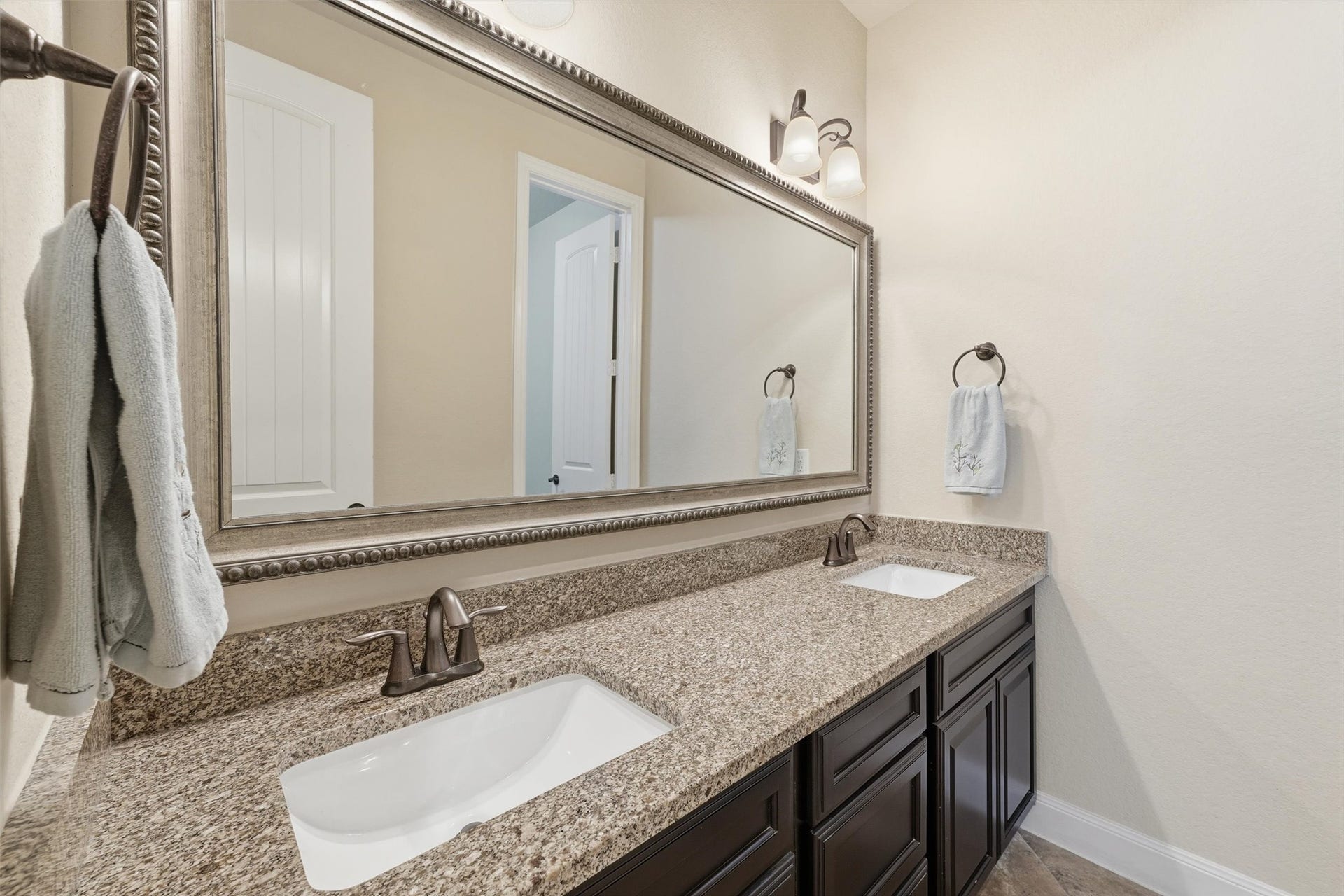 Secondary bathroom with double sinks and tub w/ shower.