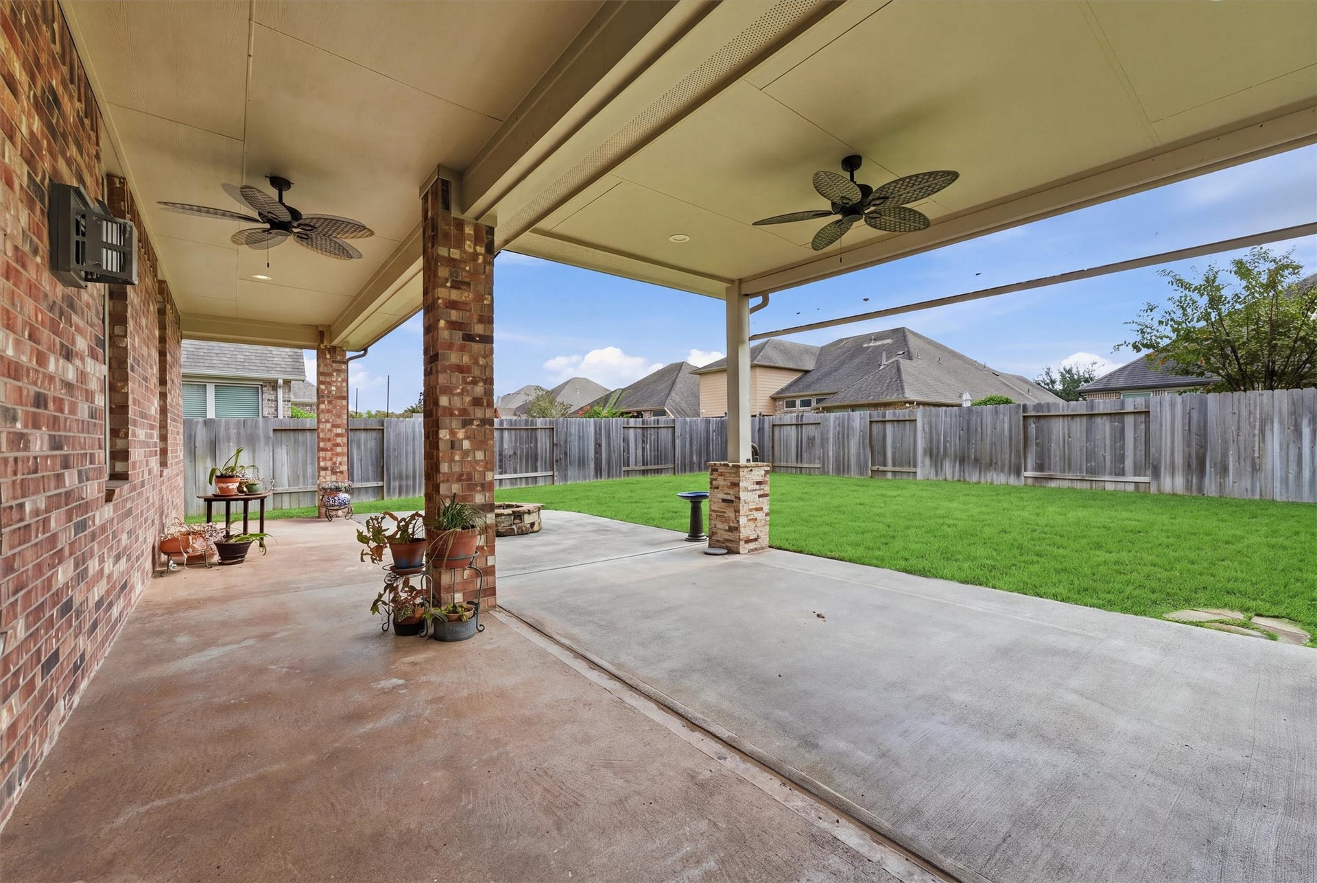 Room to dine, lounge and unwind beneath the extended covered patio, complete with ceiling fans and a roll-down shade.