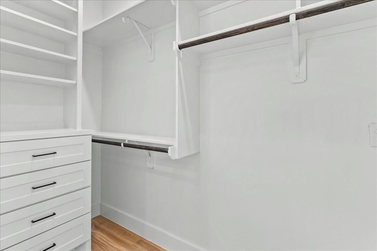 8323 Observatory Street, #A/B, Houston, TX 77088 Unit B - Walk-in primary closet features custom built-in cabinetry designed to maximize storage and organization. Custom closet design may vary. Pictures are from a previous build.