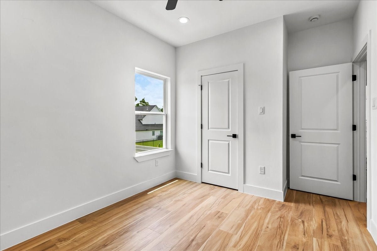 8323 Observatory Street, #A/B, Houston, TX 77088 Unit B - The secondary bedroom offers a bright and comfortable space with ample room for family, guests, or a home office.