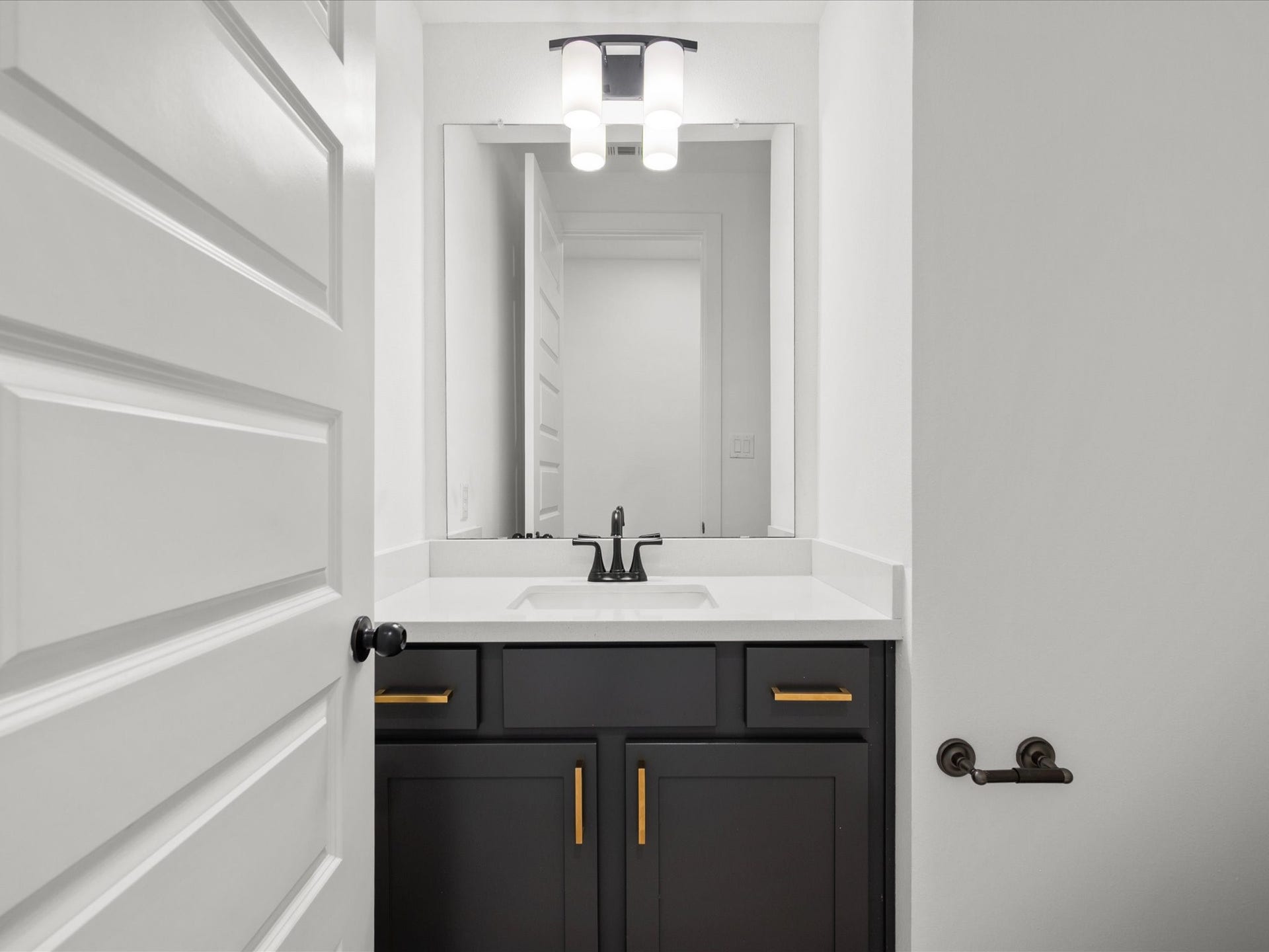1911 Golden Leaf Drive, Missouri City, TX 77459 Half bath featuring beautiful dark Cabinetry, quartz countertops, and gold fixtures