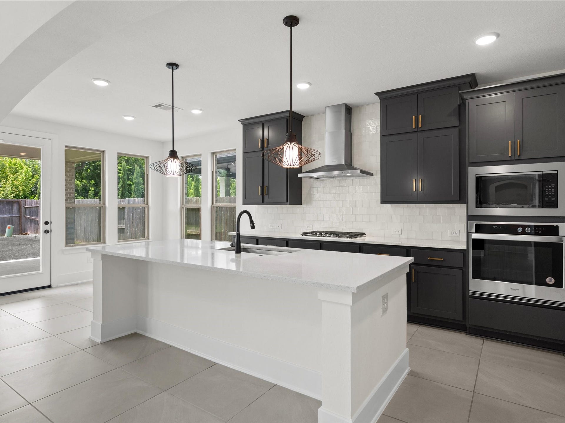 1911 Golden Leaf Drive, Missouri City, TX 77459 Chefs kitchen with a large center island, rich dark cabinetry, and quartz countertops.