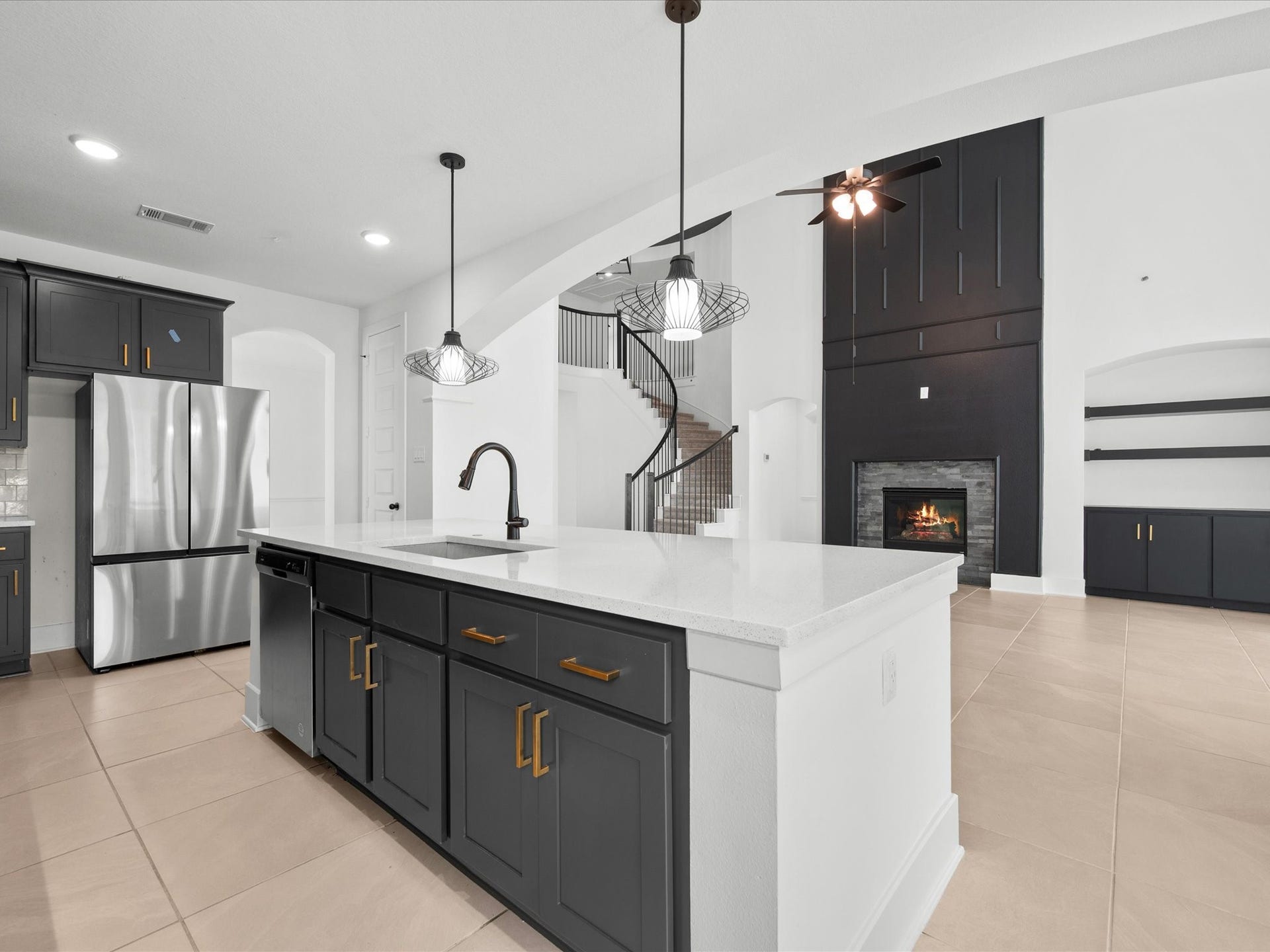 1911 Golden Leaf Drive, Missouri City, TX 77459 Kitchen island close-up showcasing quartz counters and designer pendant lighting.