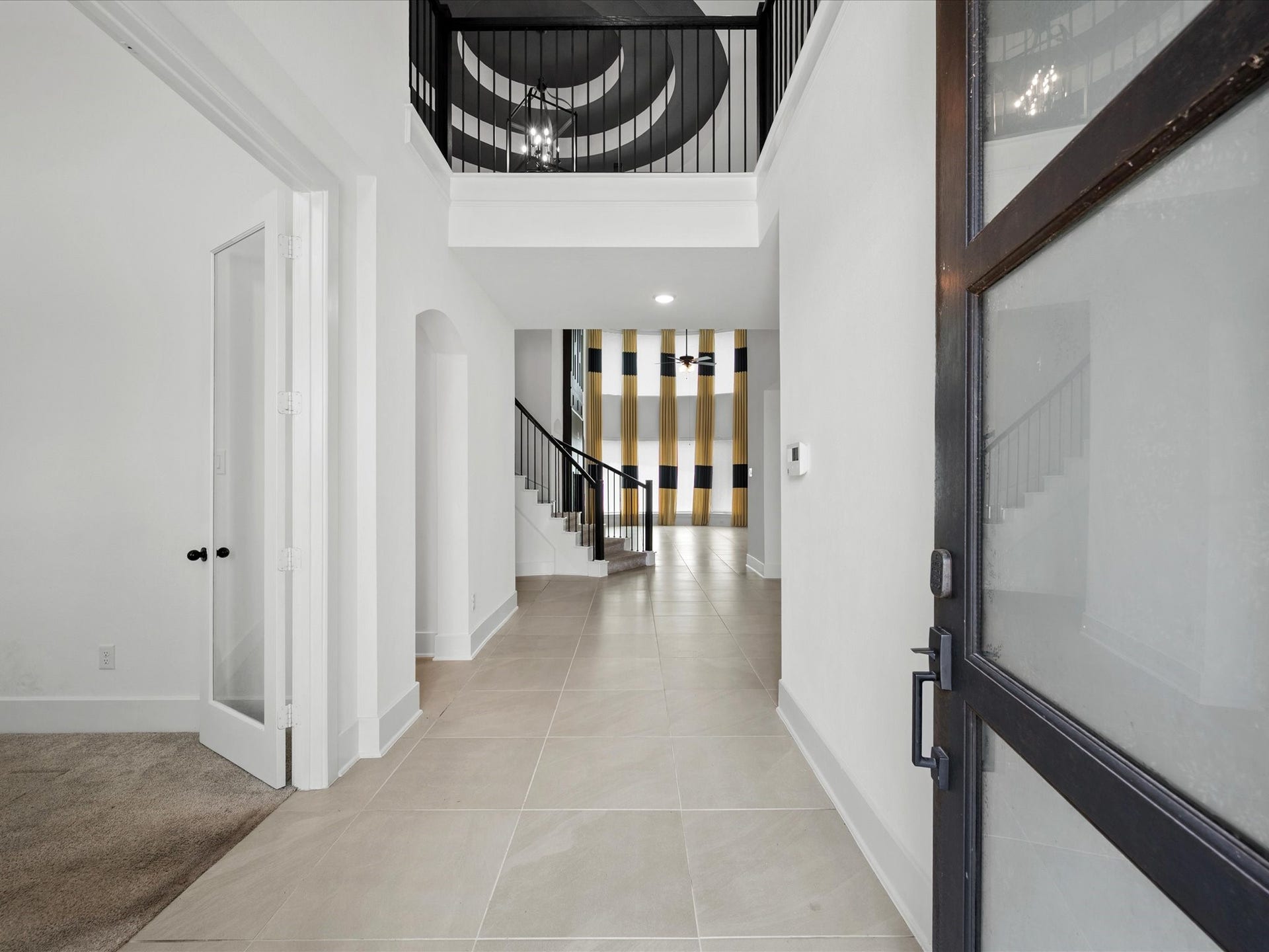 1911 Golden Leaf Drive, Missouri City, TX 77459 Wide entry hallway with modern large-format tile flooring that flows throughout the home.