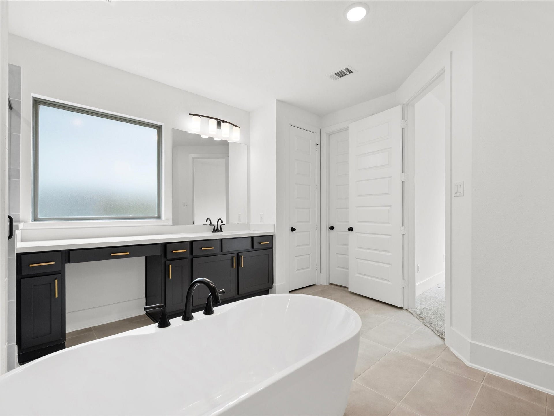 1911 Golden Leaf Drive, Missouri City, TX 77459 Primary suite vanity area with natural light and sleek finishes.