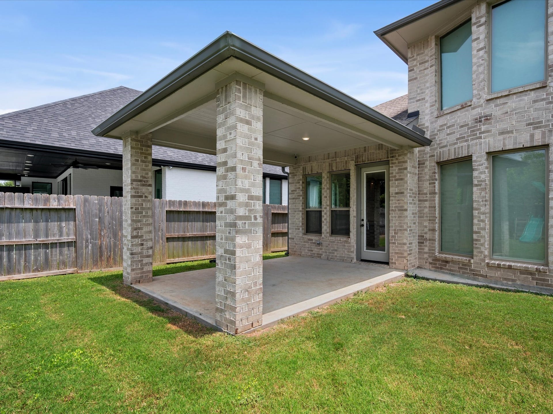 1911 Golden Leaf Drive, Missouri City, TX 77459 Rear exterior view showcasing the covered patio and homes contemporary design.