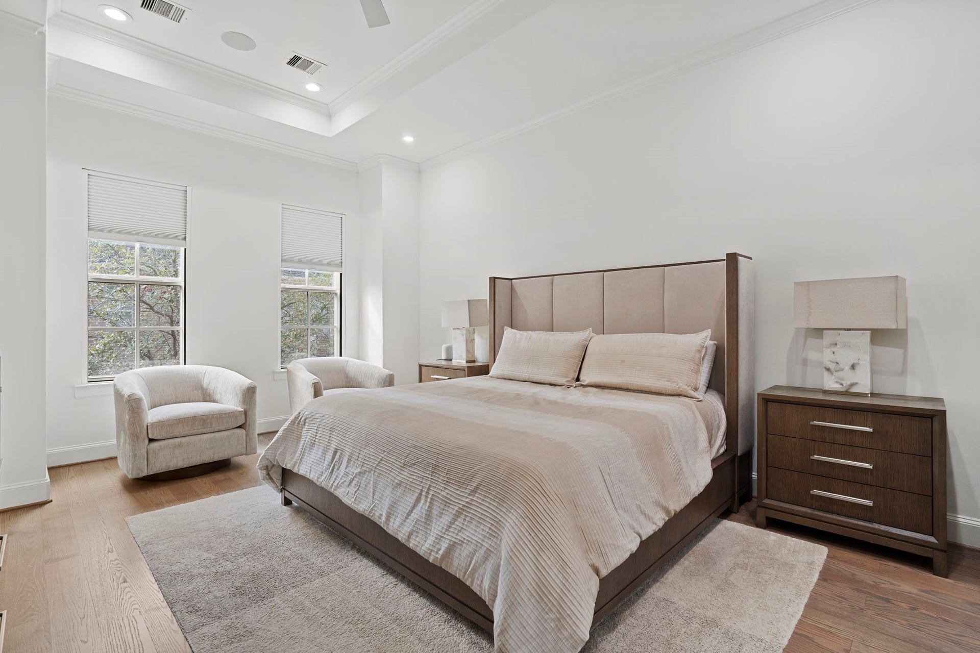 Spacious primary bedroom with natural light.