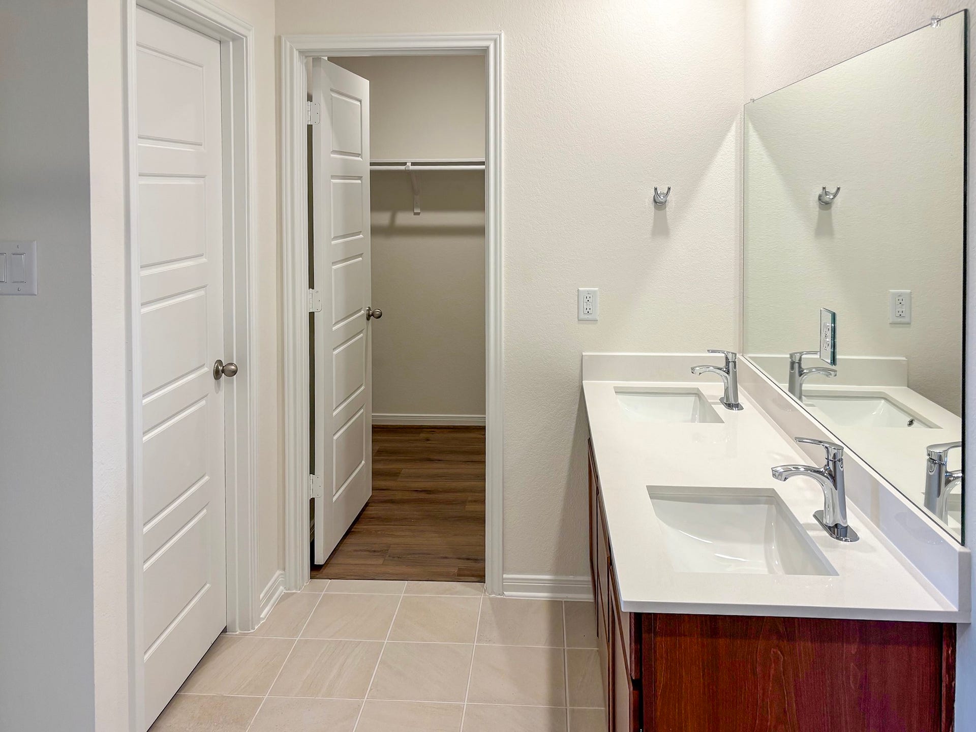 6018 Monte Thomas, Manvel, TX 77578 The ensuite primary bedroom has double sinks and a large walk-in closet,