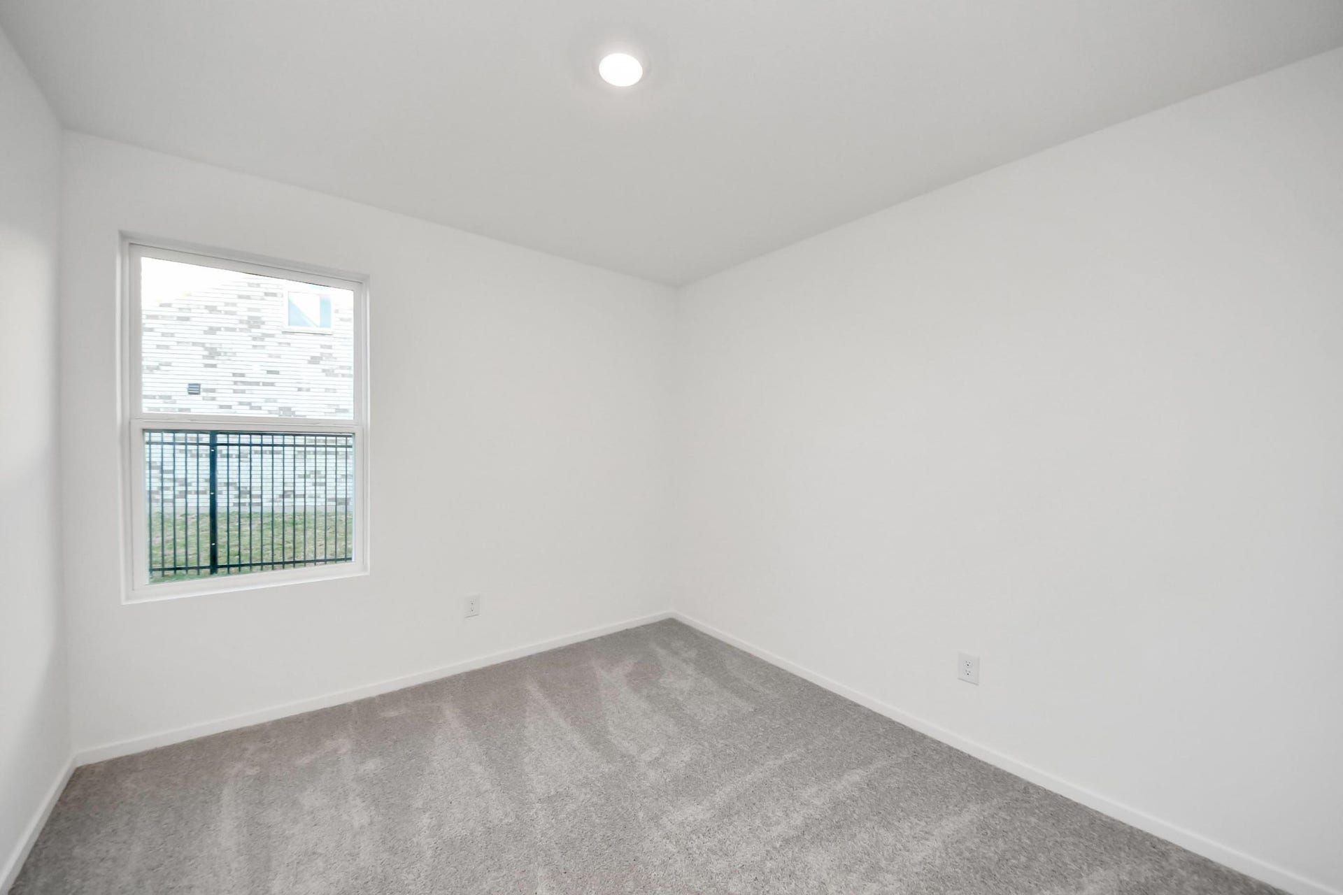 3096 Sunset Glory Drive, Katy, TX 77493 Discover Bedroom 4: a bright, inviting space with soft carpeting and a large window that bathes the room in natural lightperfect for relaxation or a cozy retreat.