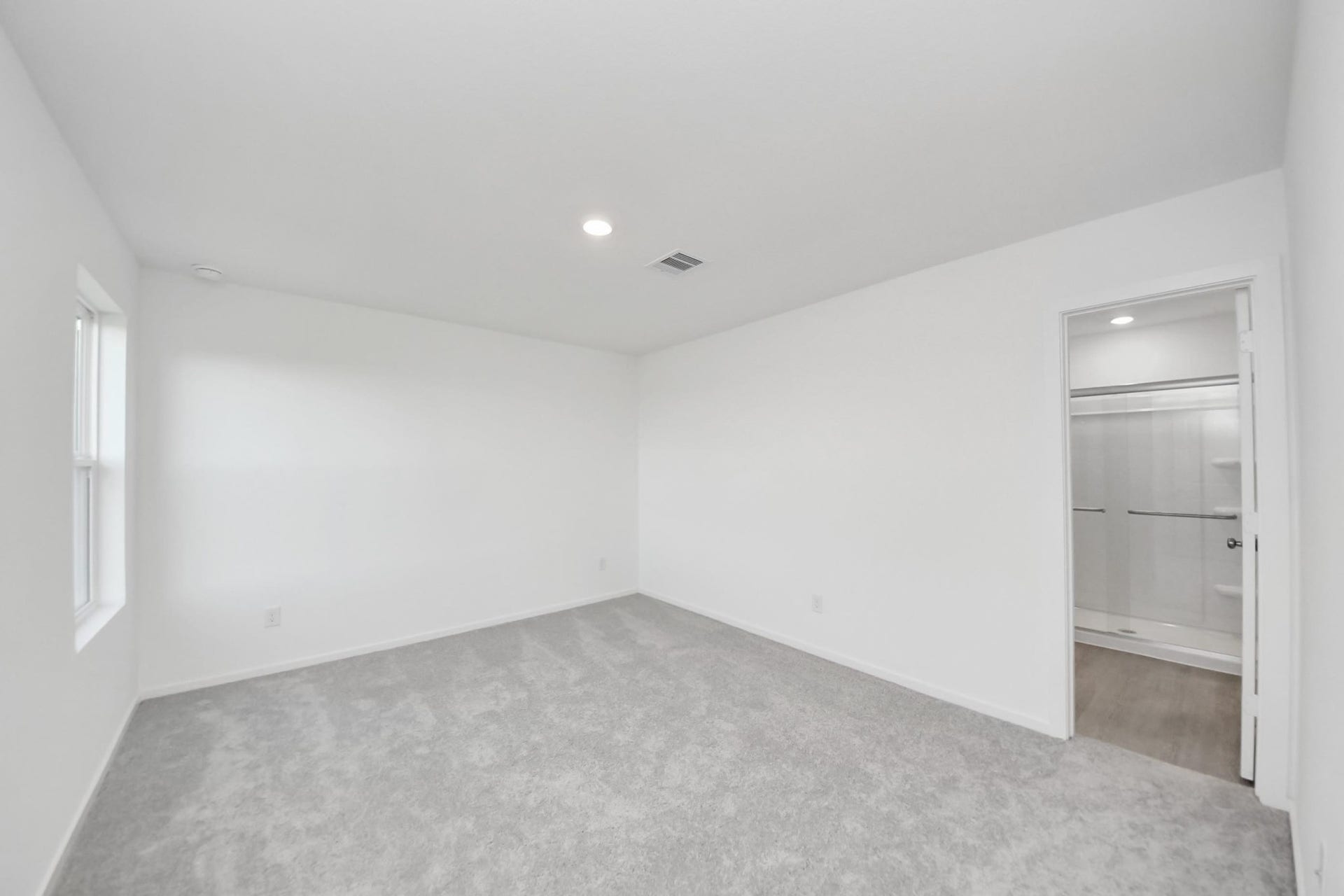 3096 Sunset Glory Drive, Katy, TX 77493 Discover serenity in this spacious primary bedroom, featuring plush carpeting, ample natural light, and a convenient walk-in closet for ultimate comfort and style.