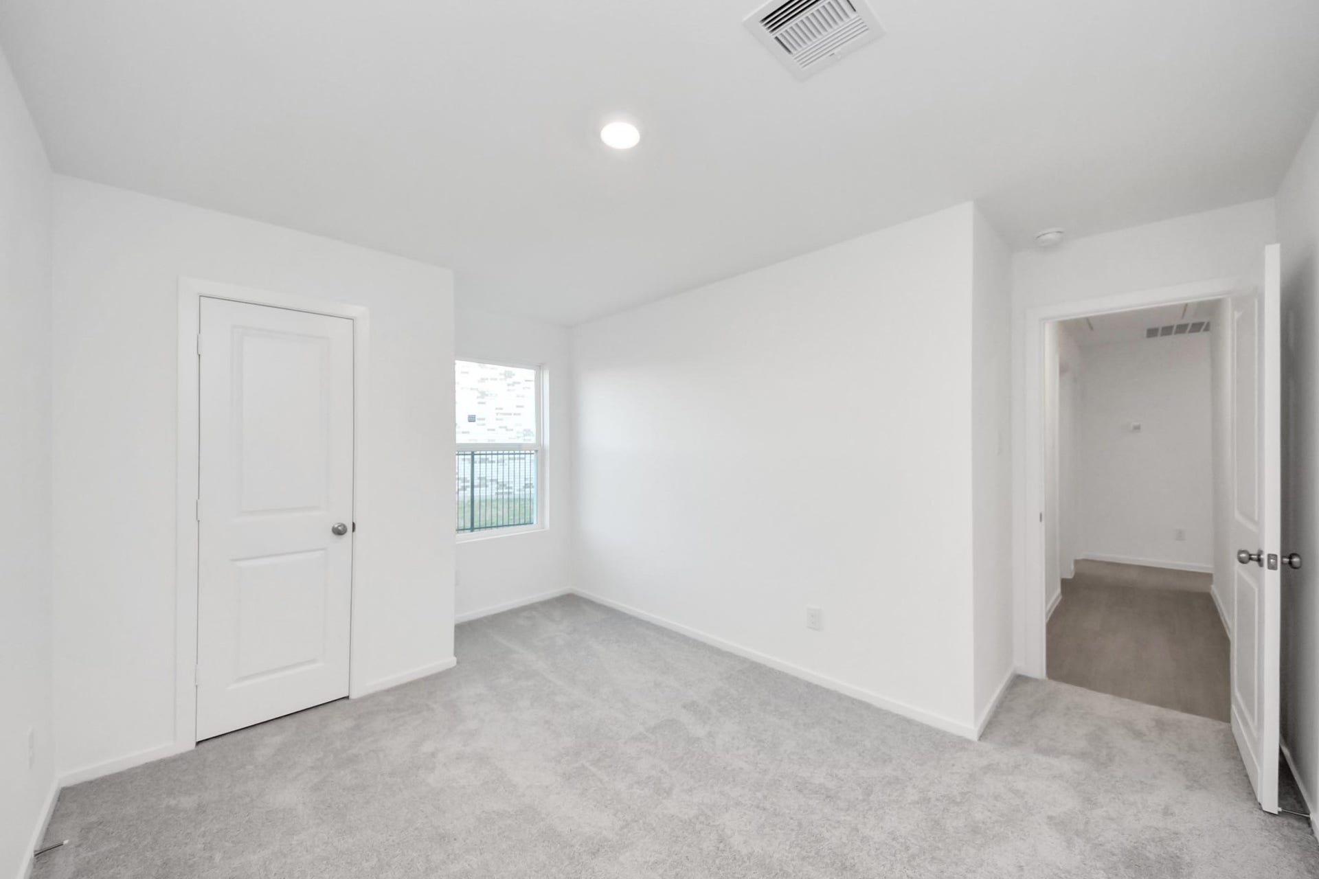3096 Sunset Glory Drive, Katy, TX 77493 Discover the serene charm of Bedroom 2, featuring soft carpeting, ample natural light, and a spacious layout perfect for relaxation or creativity.