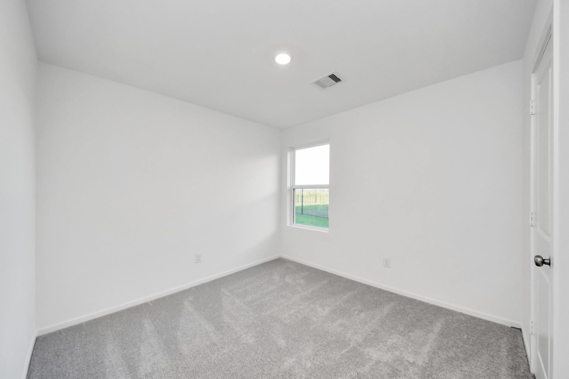 3096 Sunset Glory Drive, Katy, TX 77493 Discover the inviting charm of Bedroom 3, featuring soft carpeting, fresh white walls, and a window that fills the space with natural light and serene views.