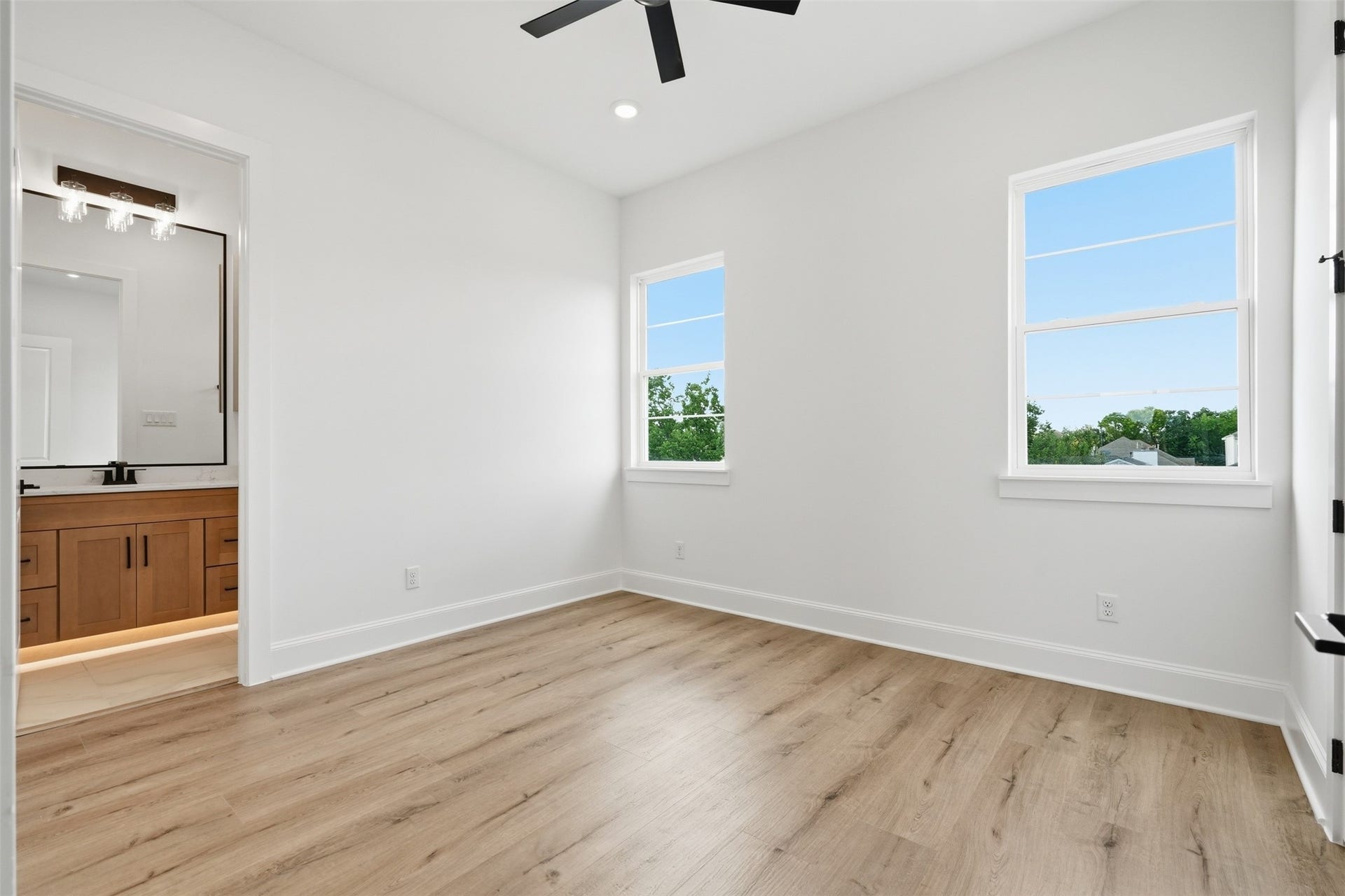 2111 Nantucket Drive, #C, Houston, TX 77057 This secondary bedroom is filled with natural light and includes direct access to a private en-suite bath.