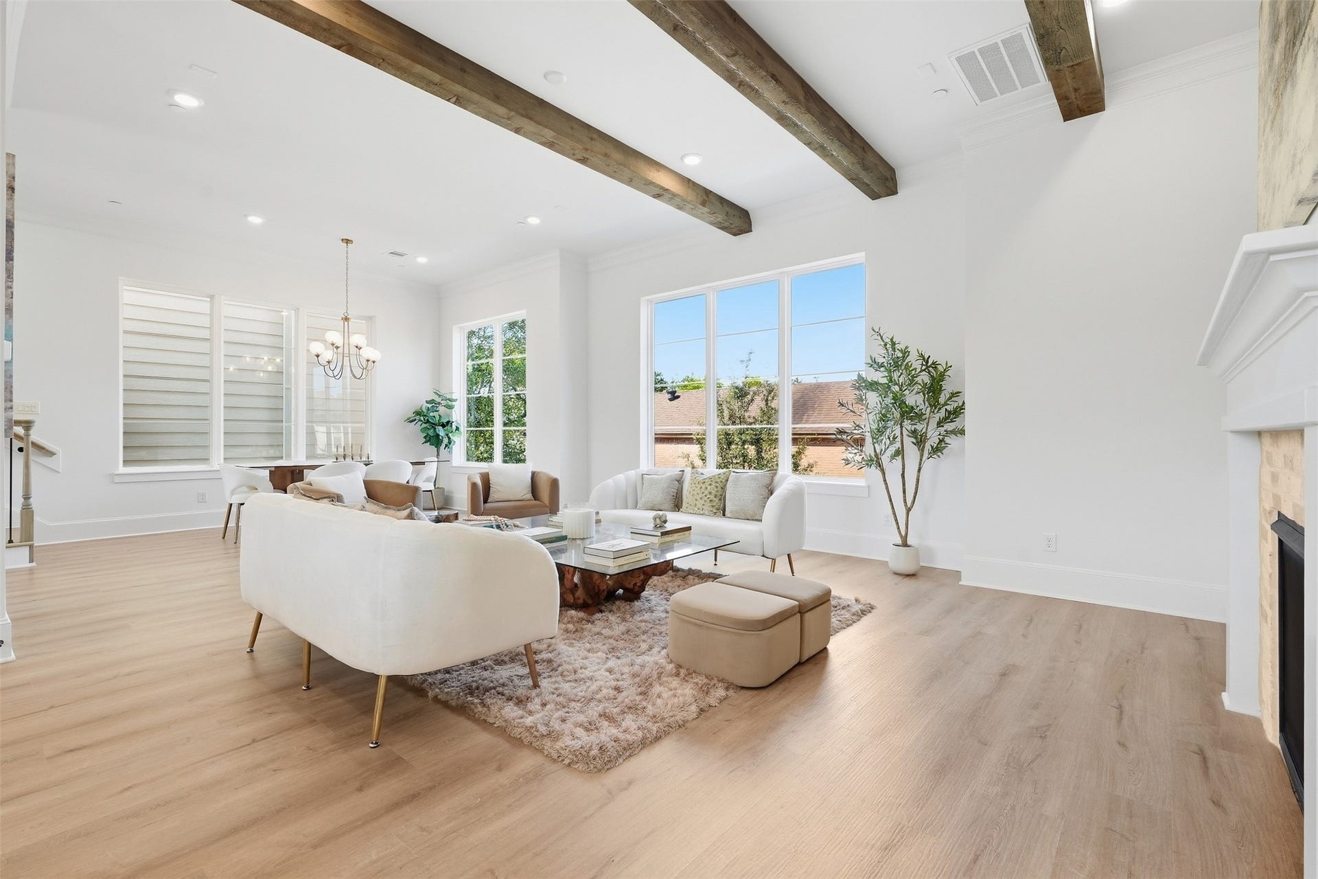 2111 Nantucket Drive, #C, Houston, TX 77057 Expansive windows fill the living area with natural light, while real cedar ceiling beams and a fireplace create a warm, inviting focal point.